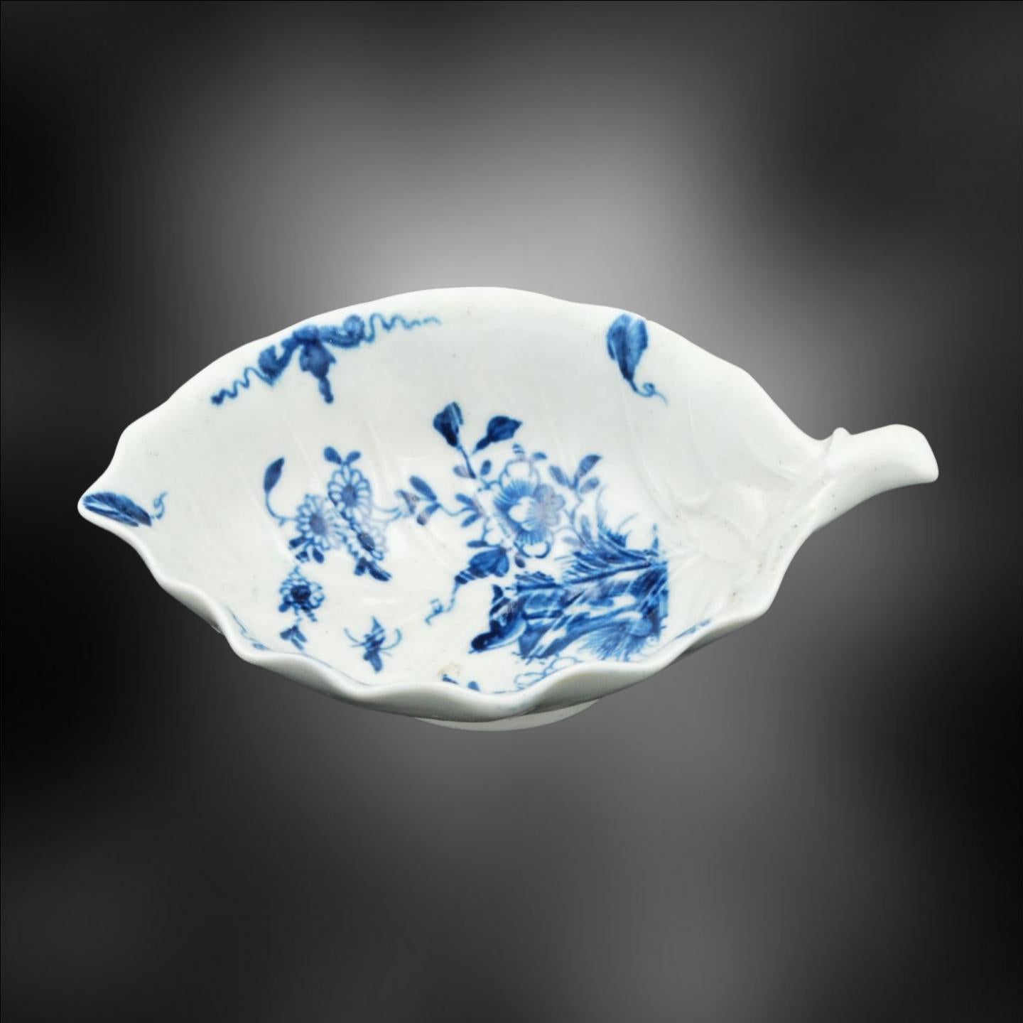 A particularly successful dish, formed in the shape of a leaf, and decorated with underglaze blue painting after the Chinese.

The Two Peony Rockbird pattern is a traditional Chinese decorative design that has been used in various forms of art and