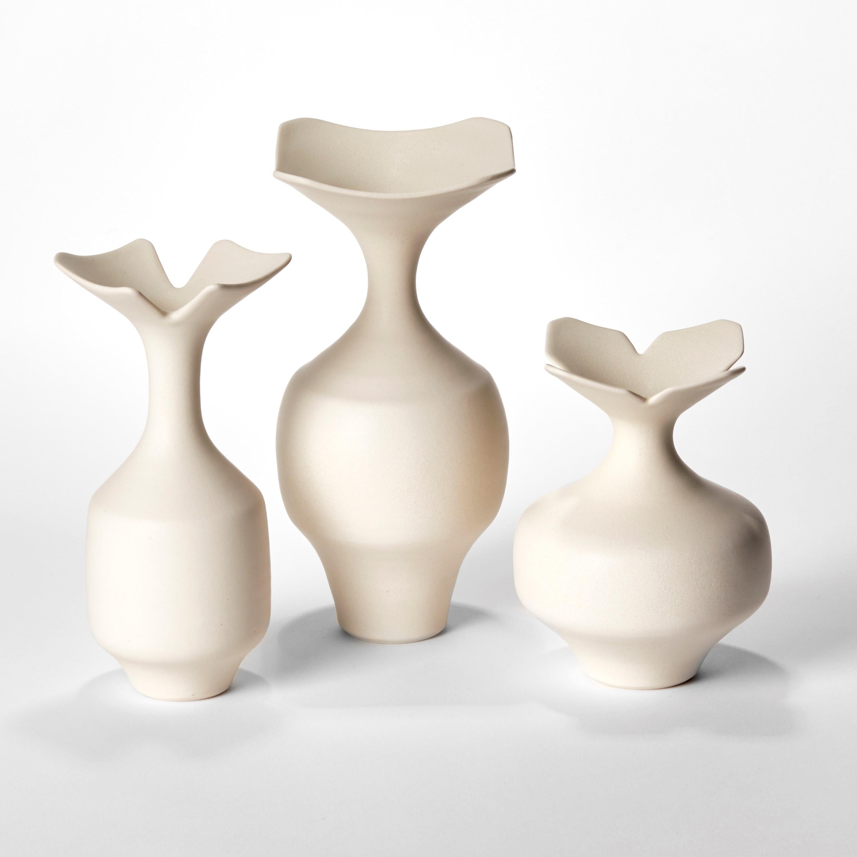 'Butter Trio’ is a unique collection of porcelain sculptural vessels by the British artist, Vivienne Foley.

Left to right in the first image:

Butter Bi-Squared Rim Vase  H 22 cm W 11.5 cm D 10 cm
Butter Tall Squared Vase  H 25 cm W 12 cm D 12