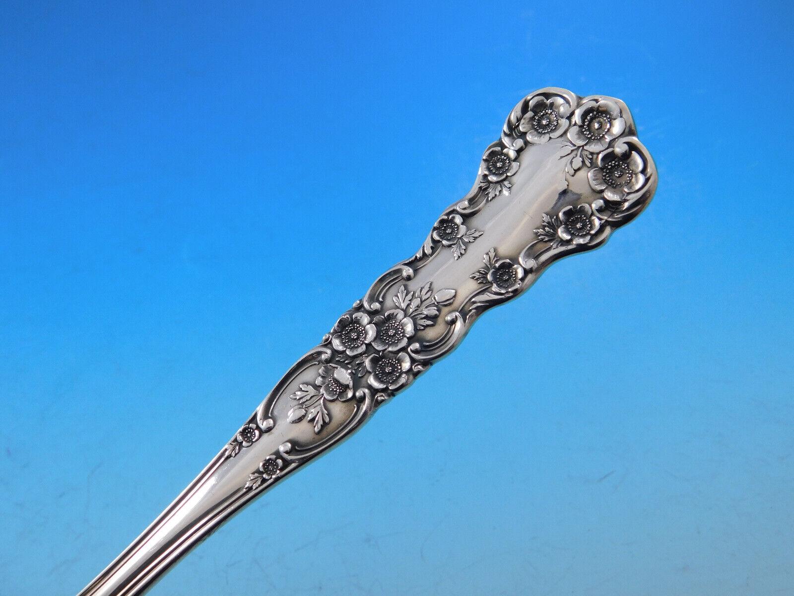 Intricately carved floral motifs carefully arranged along the handle and by the neck of this fanciful pattern are balanced by a slender central panel edged with delicate borders. Introduced in 1899, the graceful clusters of buttercups adorning each