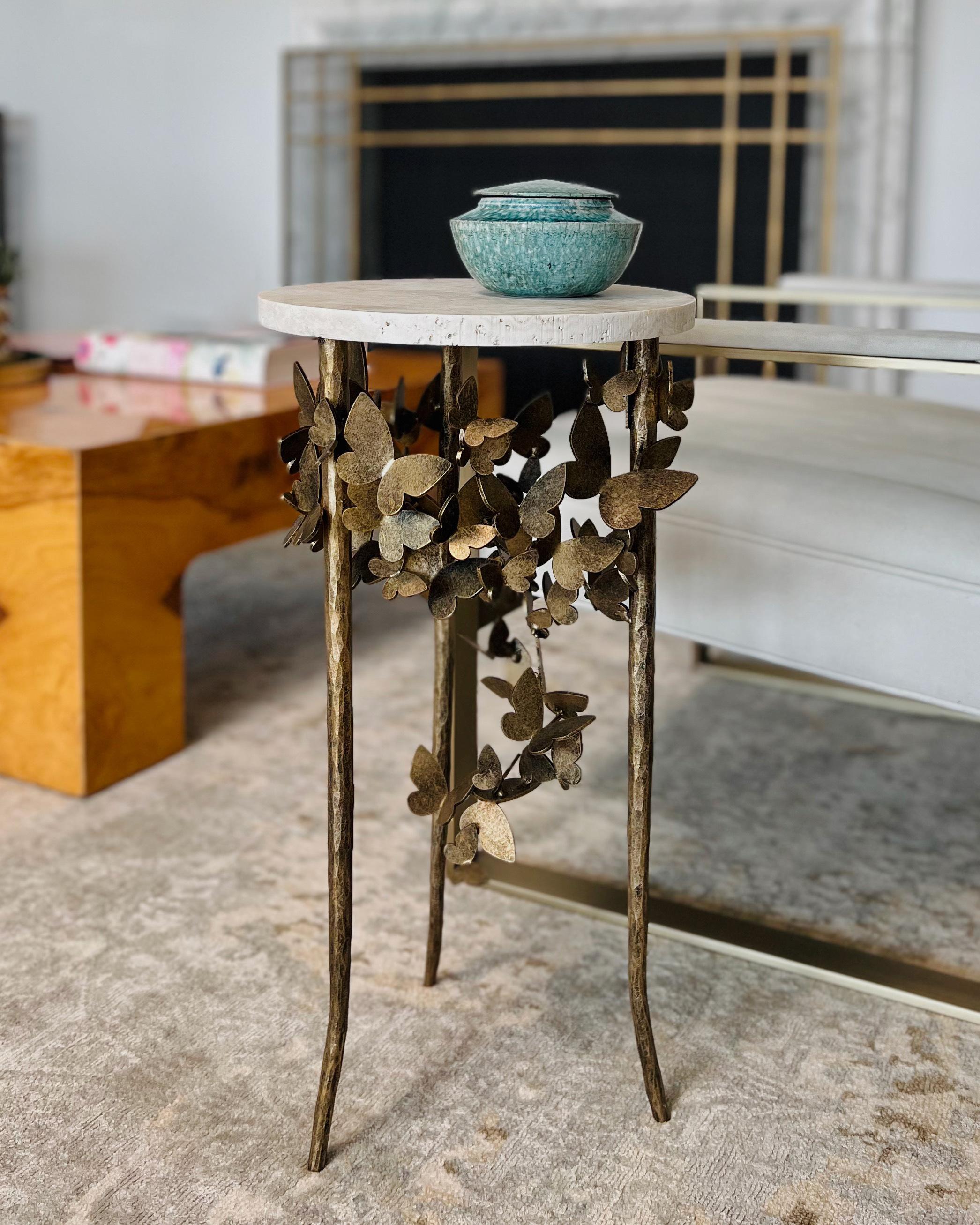 Embrace the delicate beauty of the Butterfly Accent Table, an enchanting piece that flawlessly marries form and function. The base of this table is crafted from hand-bent metal, mimicking the intricate and captivating shape of butterfly wings. Every