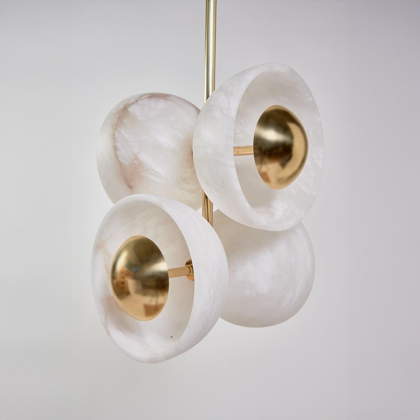 Inspired by a couple of flying butterflies, this pendant lamp enchants with its four prized alabaster cups arranged in a cluster of striking sculptural flair. The romantic zoomorphic inspiration gets sealed by the streamlined polished brass