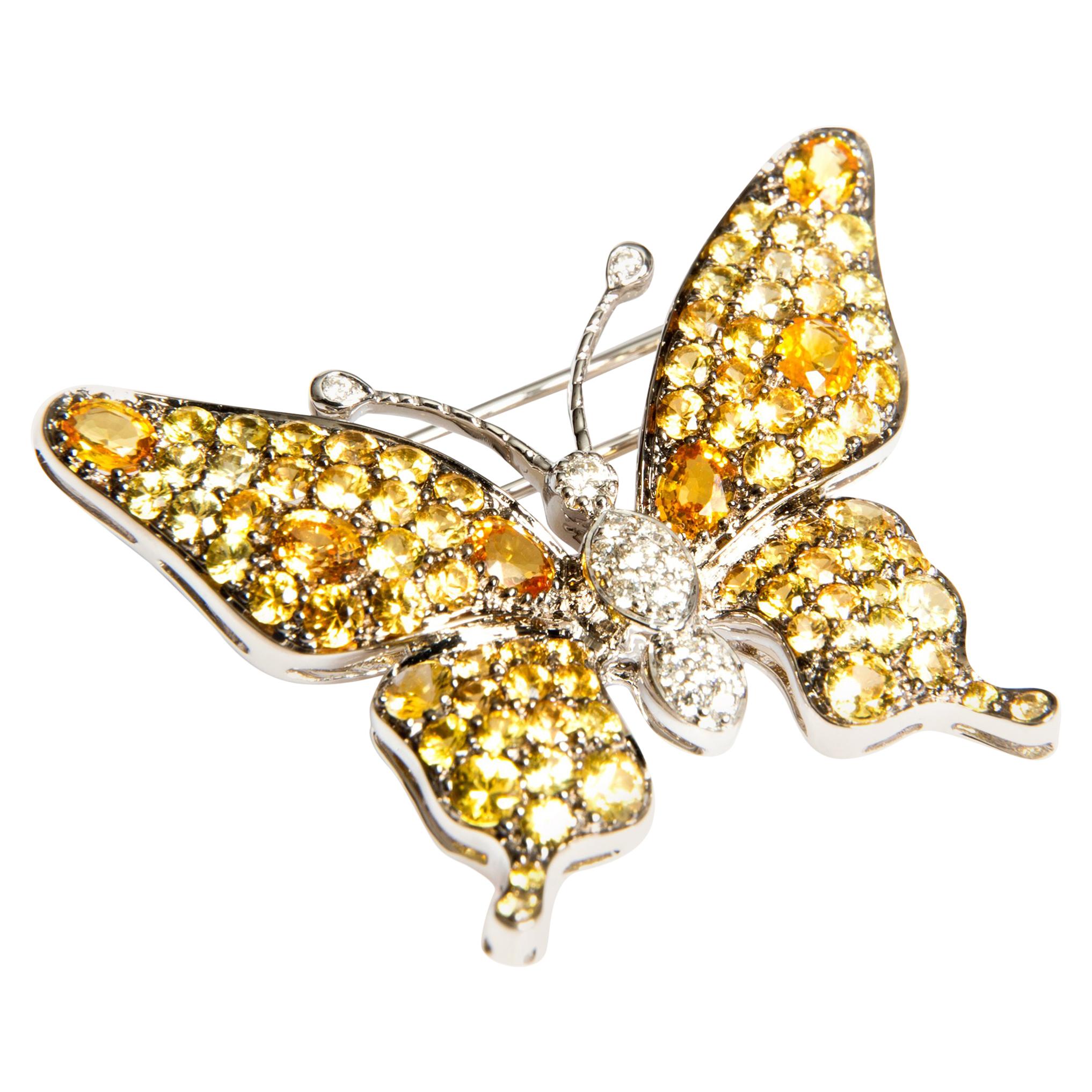 Set in 18K white gold, this glittering handcrafted brooch black rhodinated, features 17 diamonds 0.20 carat and 84 yellow sapphires 5.20 carats. 
Add a flutter of charm to any outfit with this elegant brooch. Perfect for weddings and special