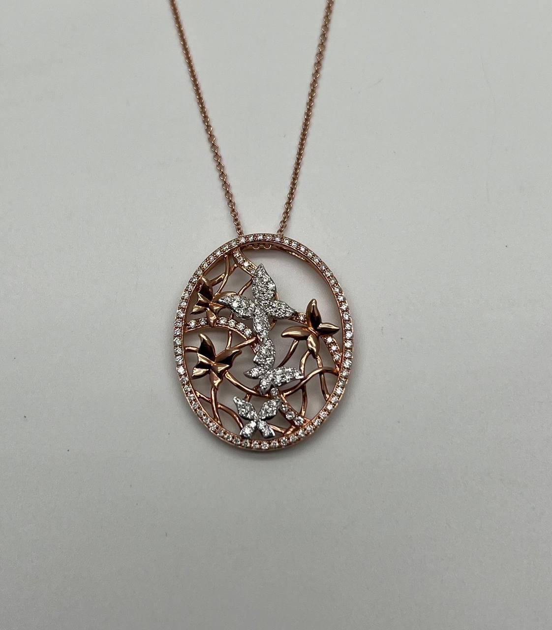 A captivating pendant necklace, featuring an intricate design with diamond-studded butterfly motifs set in a delicate circular frame. The piece showcases a harmonious blend of rose gold and white diamonds, creating a striking contrast. 14K Rose