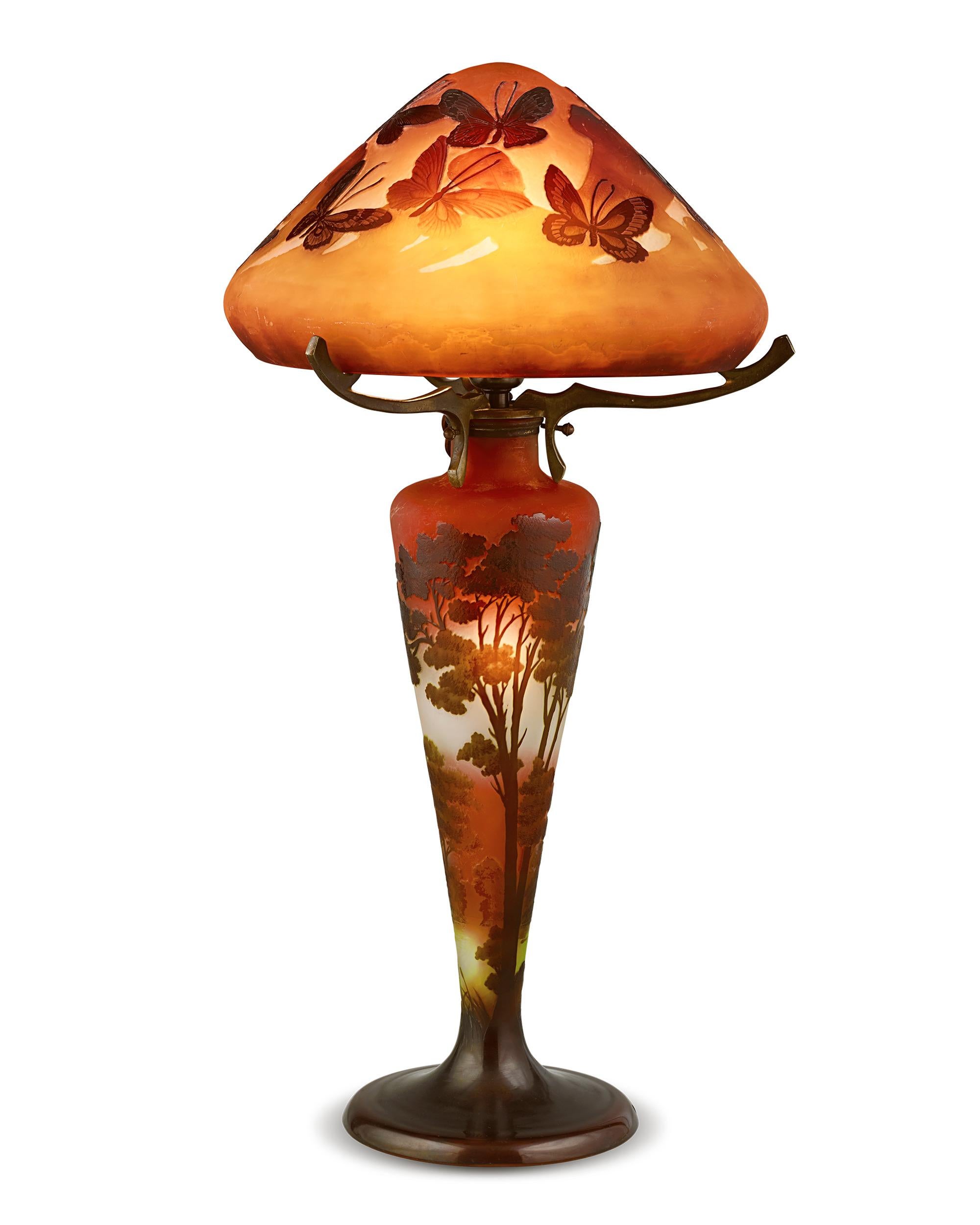 Impressive in both size and artistry, this magnificent lamp is the work of the famed Art Nouveau master Émile Gallé, one of the most highly regarded names in French glassmaking. The artist's appreciation of nature is evident in the detailed
