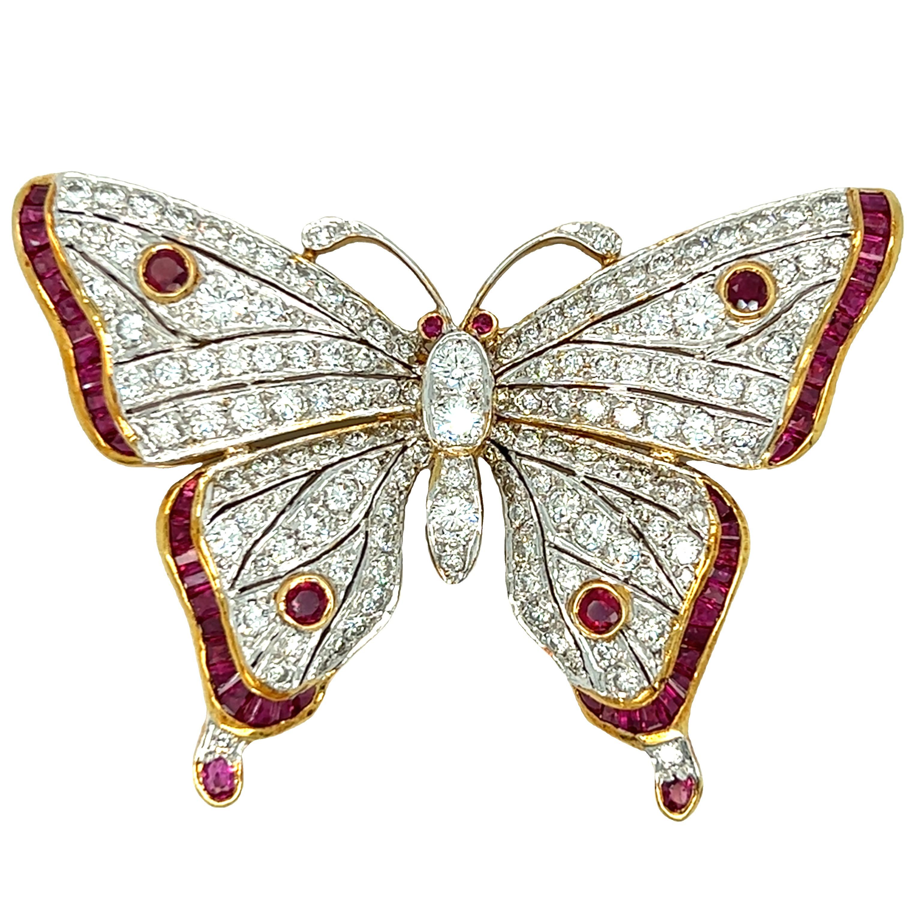 Elegant. Glittering. Majesty. A stunning vintage butterfly brooch with exceptional quality and grand dimensions, the wings are decorated with round diamonds set in 18K white gold and bordered with square cut rubies. The thorax and abdomen are formed