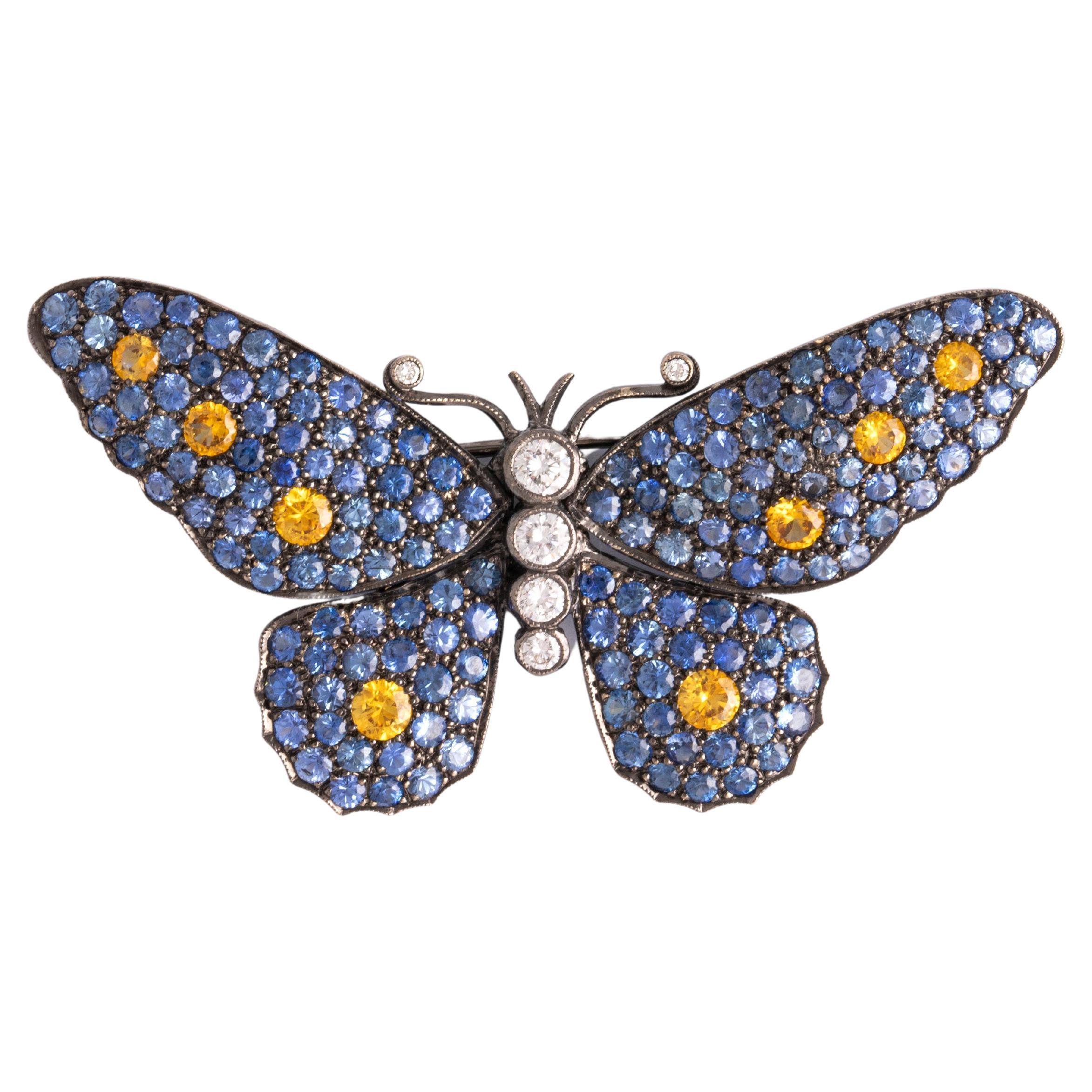 Butterfly Brooch 18K gold blacken set with diamonds and yellow and blue sapphires (treated).
Height: 3.00 centimeters.
Width: 5.70 centimeters.
Total weight: 11.76 grams.
