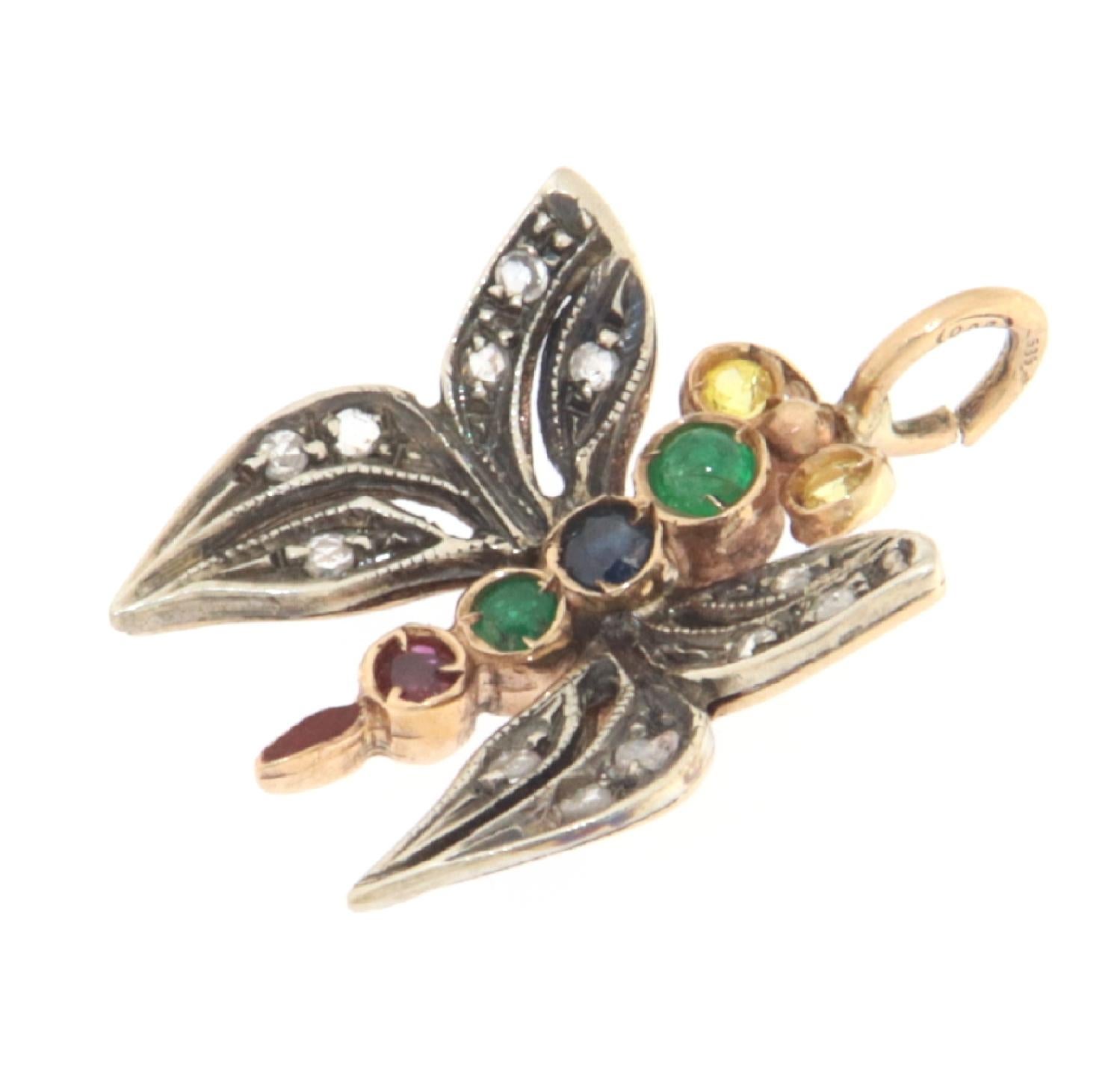 This exceptional butterfly-shaped pendant, beautifully crafted in a blend of 14-karat yellow gold and sterling silver, is a masterpiece of jewelry art that celebrates the intricate beauty and craftsmanship of nature. With a detail-rich design, this