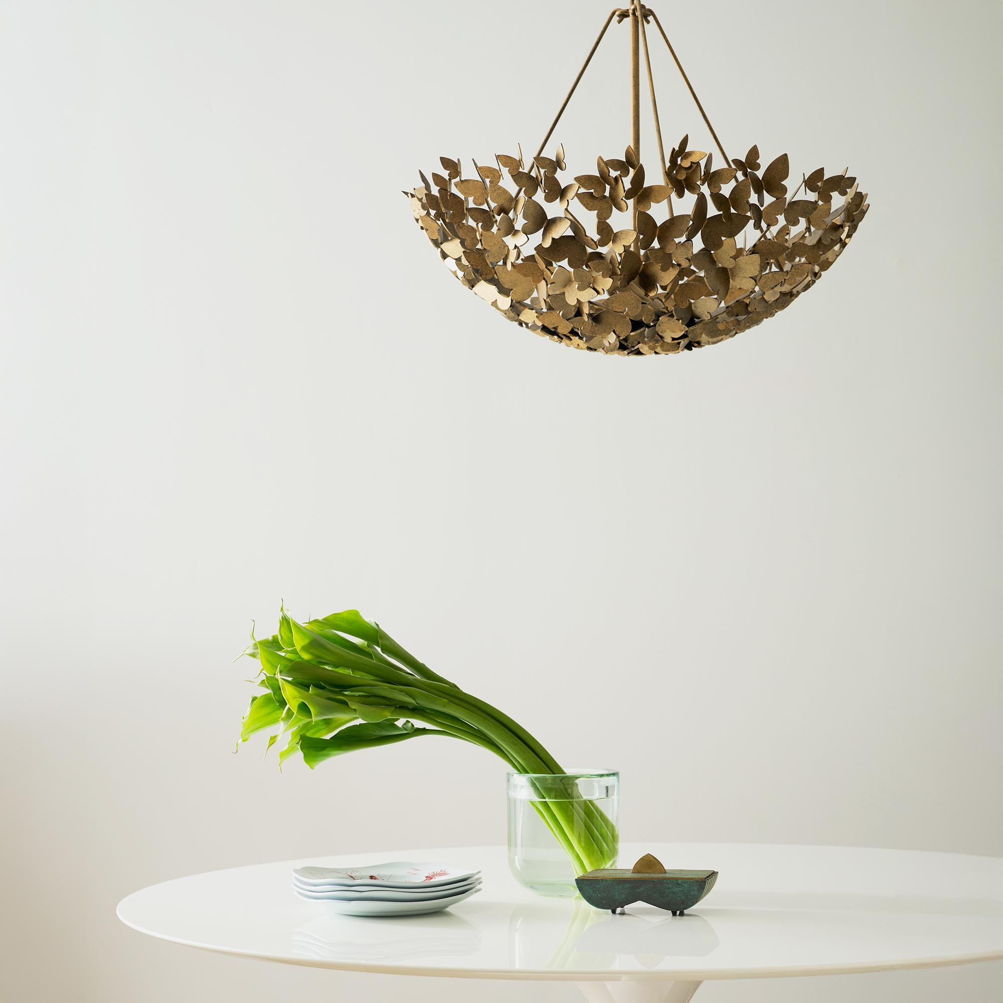 Delicate wings form an elegant, sculptural shape that brings both drama and a touch of sophisticated allure to any space. The Hanging Butterfly Dish Light is a stunning fusion of artistry and function, with gracefully layered butterflies that seem