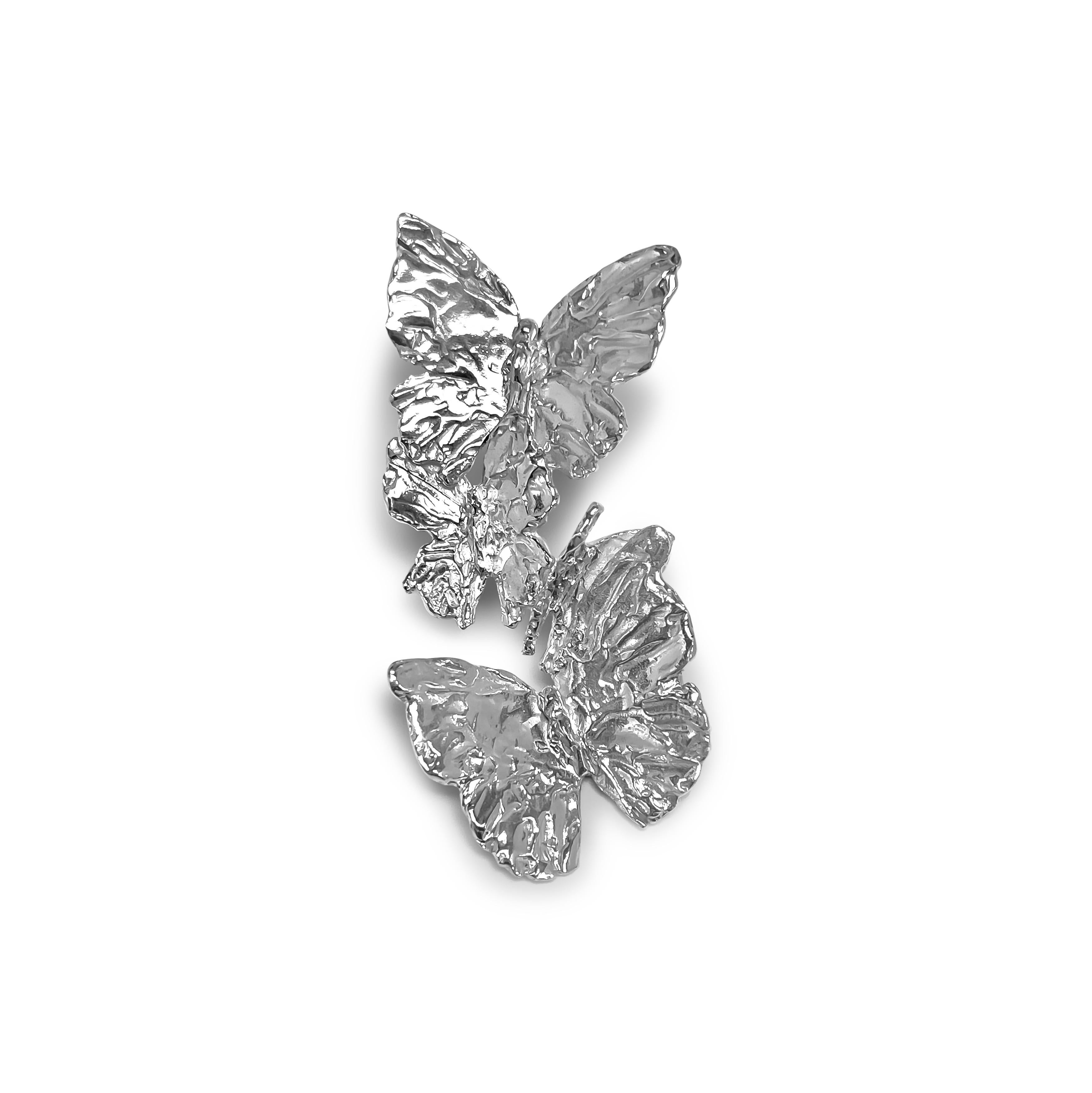 Intention: Metamorphosis 

Design: A wearable reminder of one of the delicate butterfly's superpower. Wear it, and step into your own. Four hand carved butterflies balance just so to alight on the ear, drawing attention to your face and eyes.