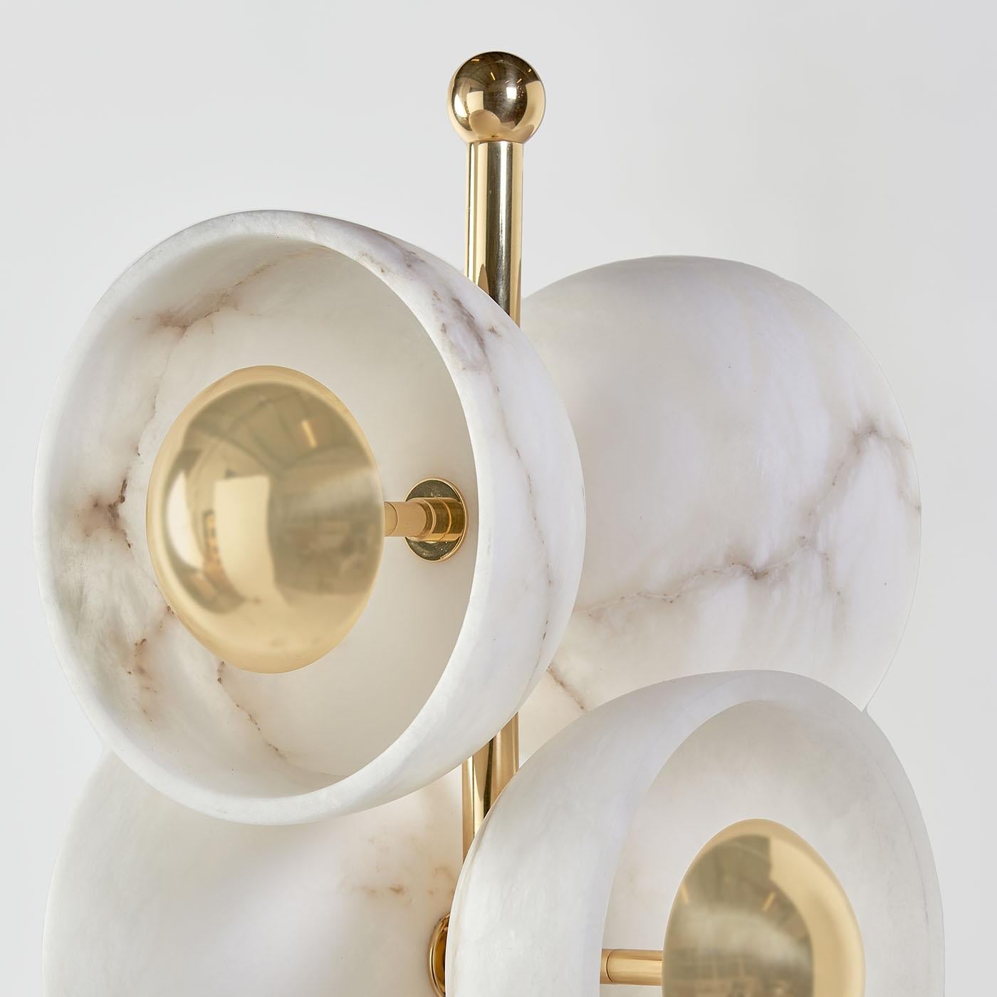 The Butterfly floor lamp is a beautiful and unique piece that can bring a touch of elegance to any contemporary setting. Using alabaster cups and polished brass covers creates a delicate and airy design resembling butterflies' wings. The hidden