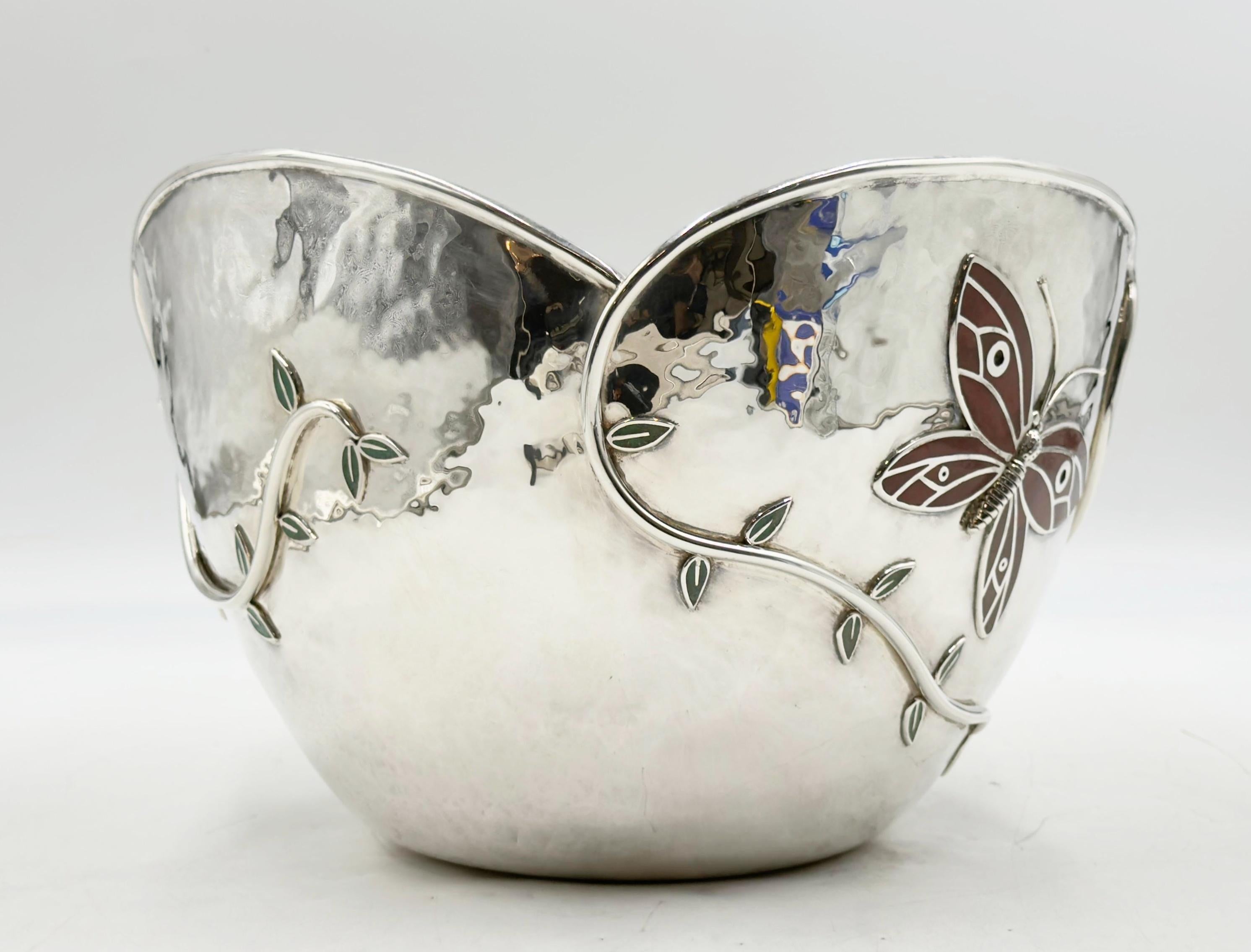 This enchanting ice bucket by celebrated Mexican designer Emilia Castillo captures the whimsy of nature with its sculptural butterfly and vine motif. Crafted in silver plate, the piece features inlays of rich red jasper and crushed turquoise, adding