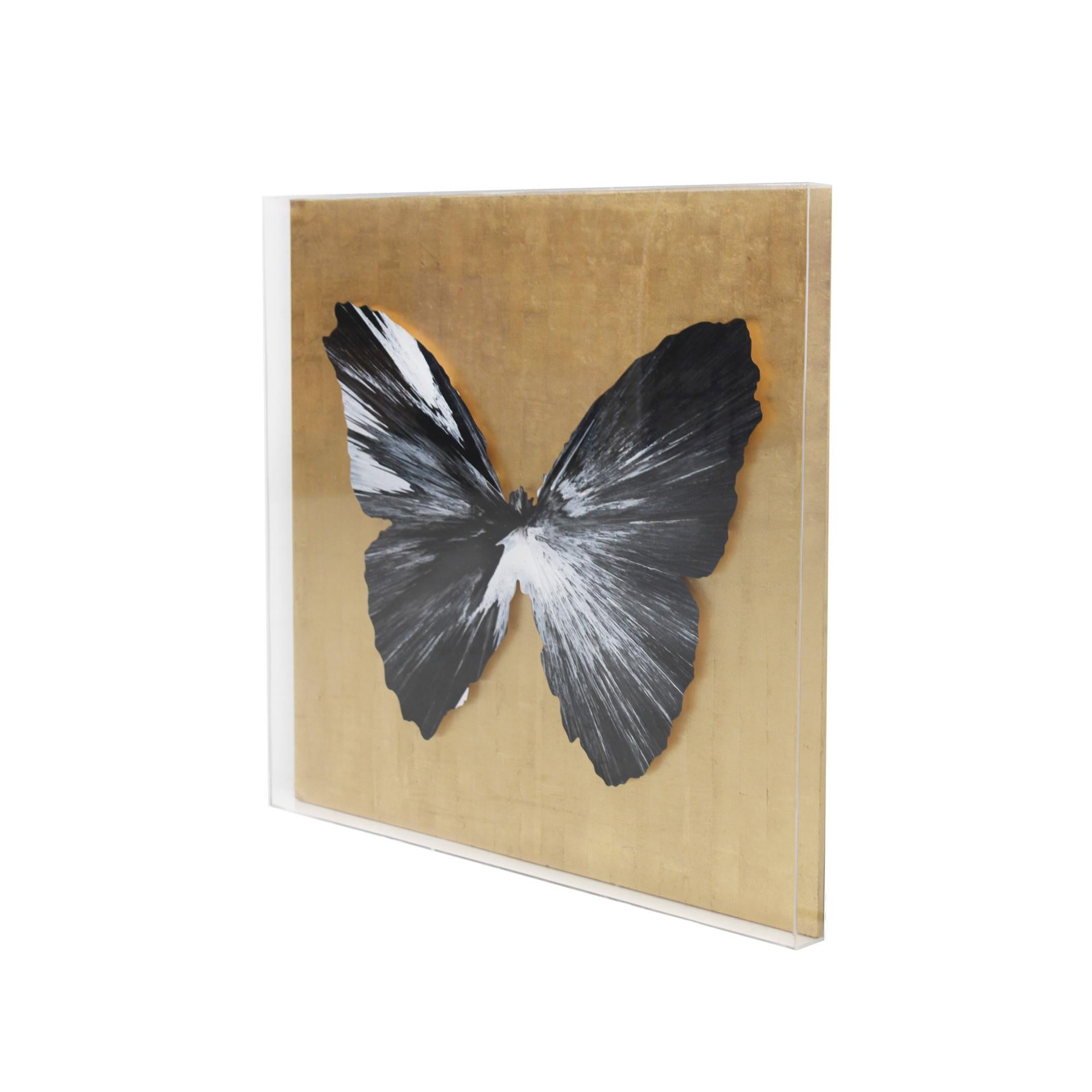 Butterfly Spin Painting by artist Damien Hirst.

Work in acrylic, framed in a methacrylate case with transparent sides and a wooden background in gold leaf that reveals the artist's signature on the back.

This piece of art was made to celebrate the