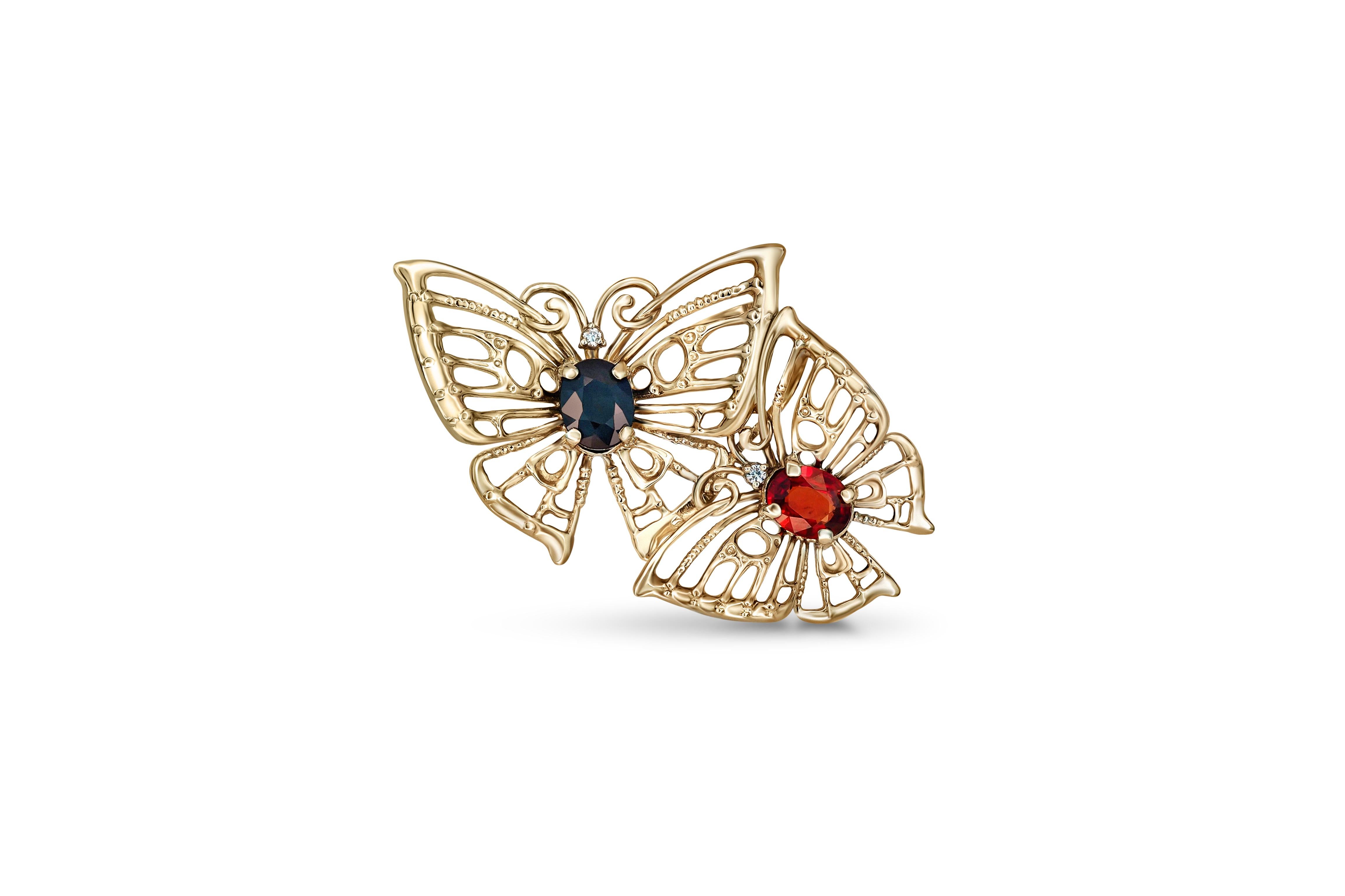 Butterfly pendant with sapphires in 14k gold. 
Two Butterfly pendant. Red, blue sapphires gold pendant. Oval sapphires pendant.

Metal: 14k gold
32x20.5 mm size
Weight 2.30 gr.

Gemstones: 
Sapphire: 0.8 ct, blue color, transparent with inclusions,