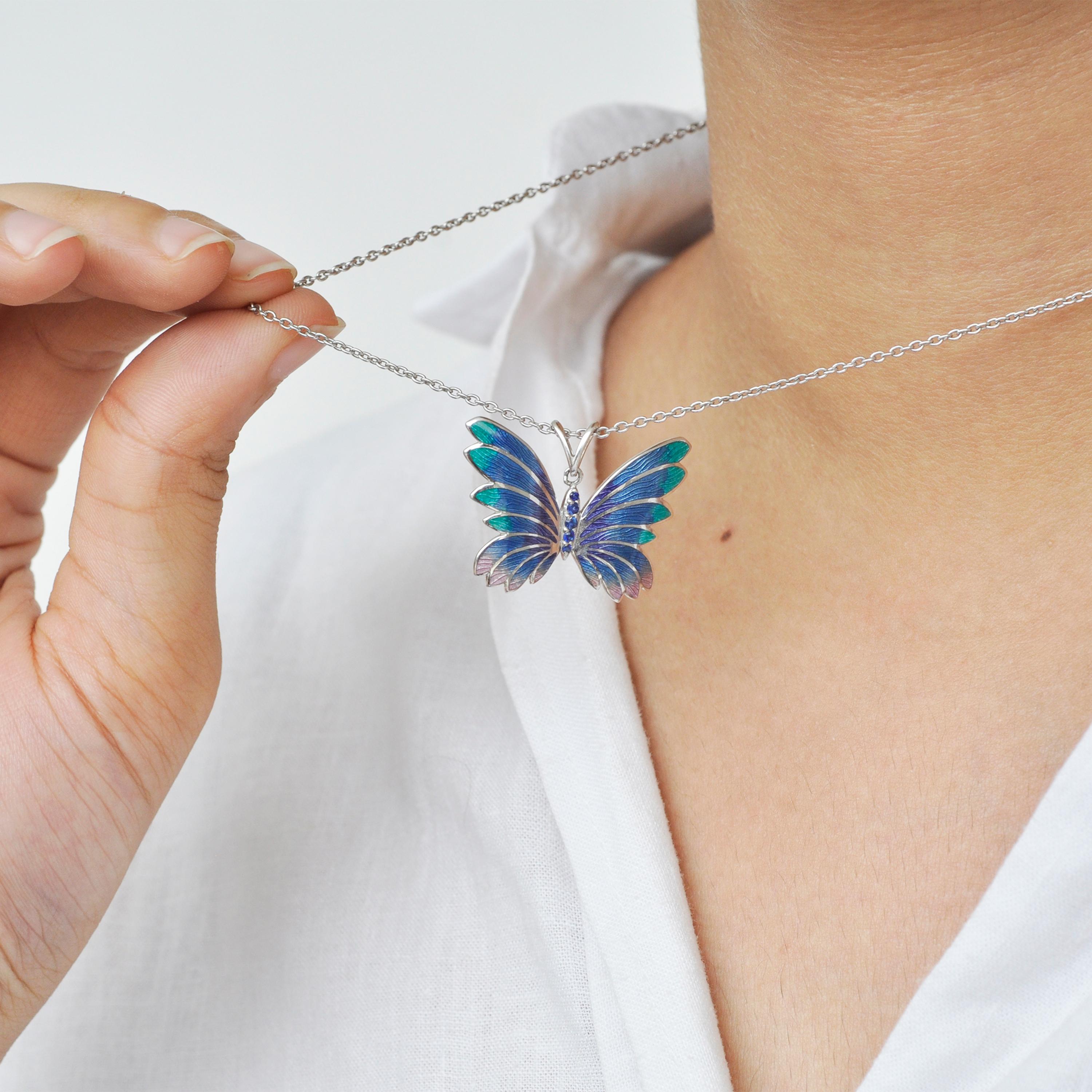This stunning Sterling Silver Butterfly pendant with shades of Plique-à-Jour enamelling is delicately detailed with five blue lab created sapphires on the body. The pendant has two loops on the upper side which can easily pass a chain through to be