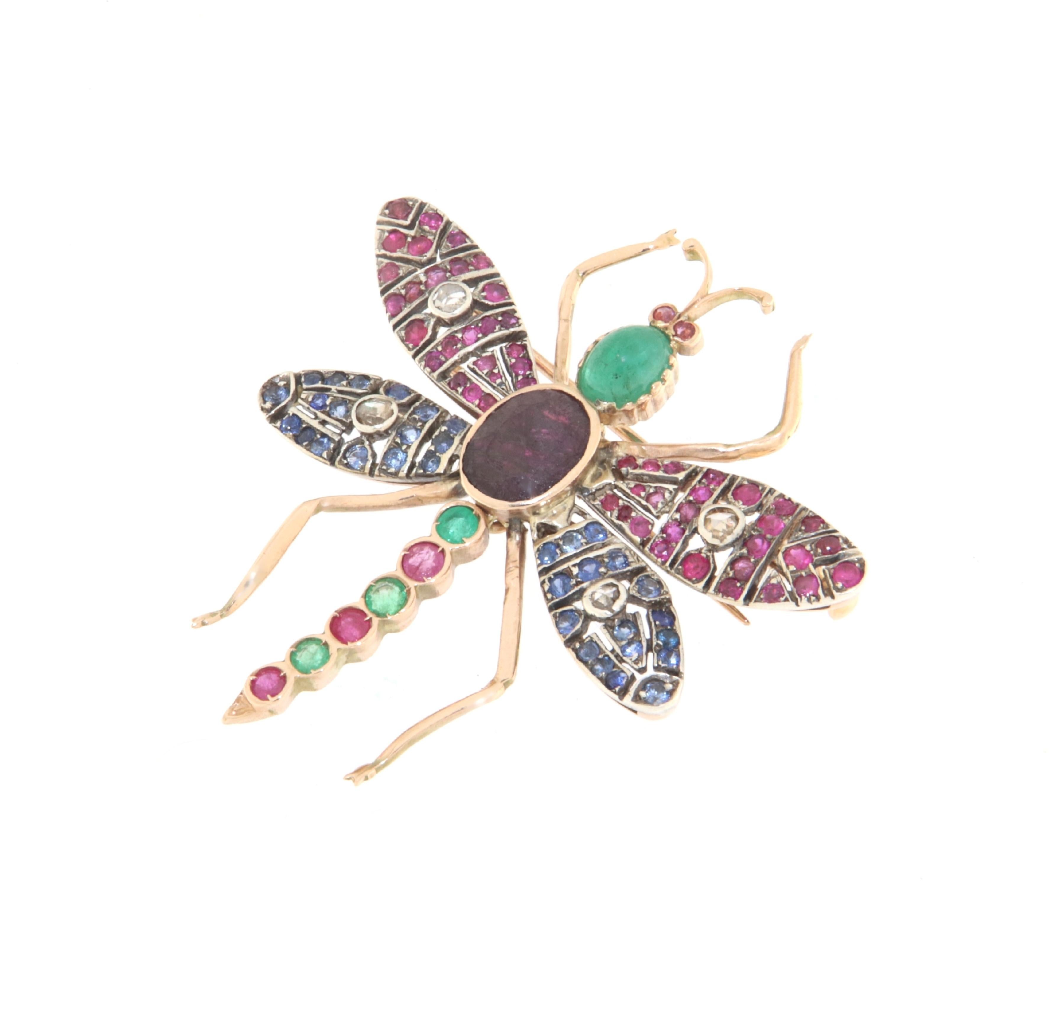 This butterfly brooch is an extraordinary example of jewelry craftsmanship, beautifully crafted in 14-karat yellow gold and 800 silver, adorned with a selection of rose-cut diamonds, rubies, sapphires, and emeralds. The combined design and choice of