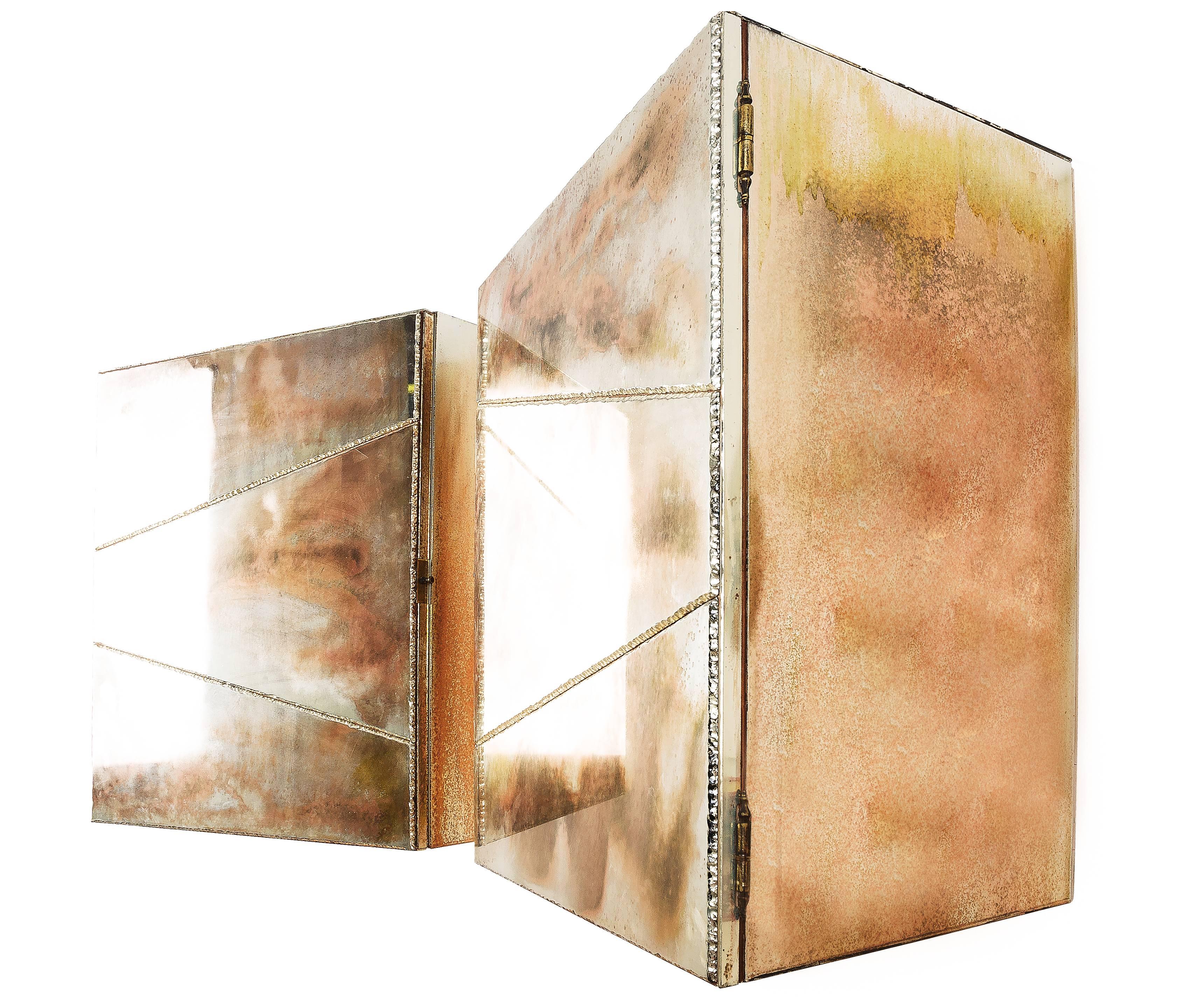 This object is a contemporary piece, entirely made in Tuscany, Italy and 100% of Italian origin. 
 
An suspended cabinet, inspired by the sense of freedom, made of silvered glass wings and solid birch wood, internally treated with natural wax.
The