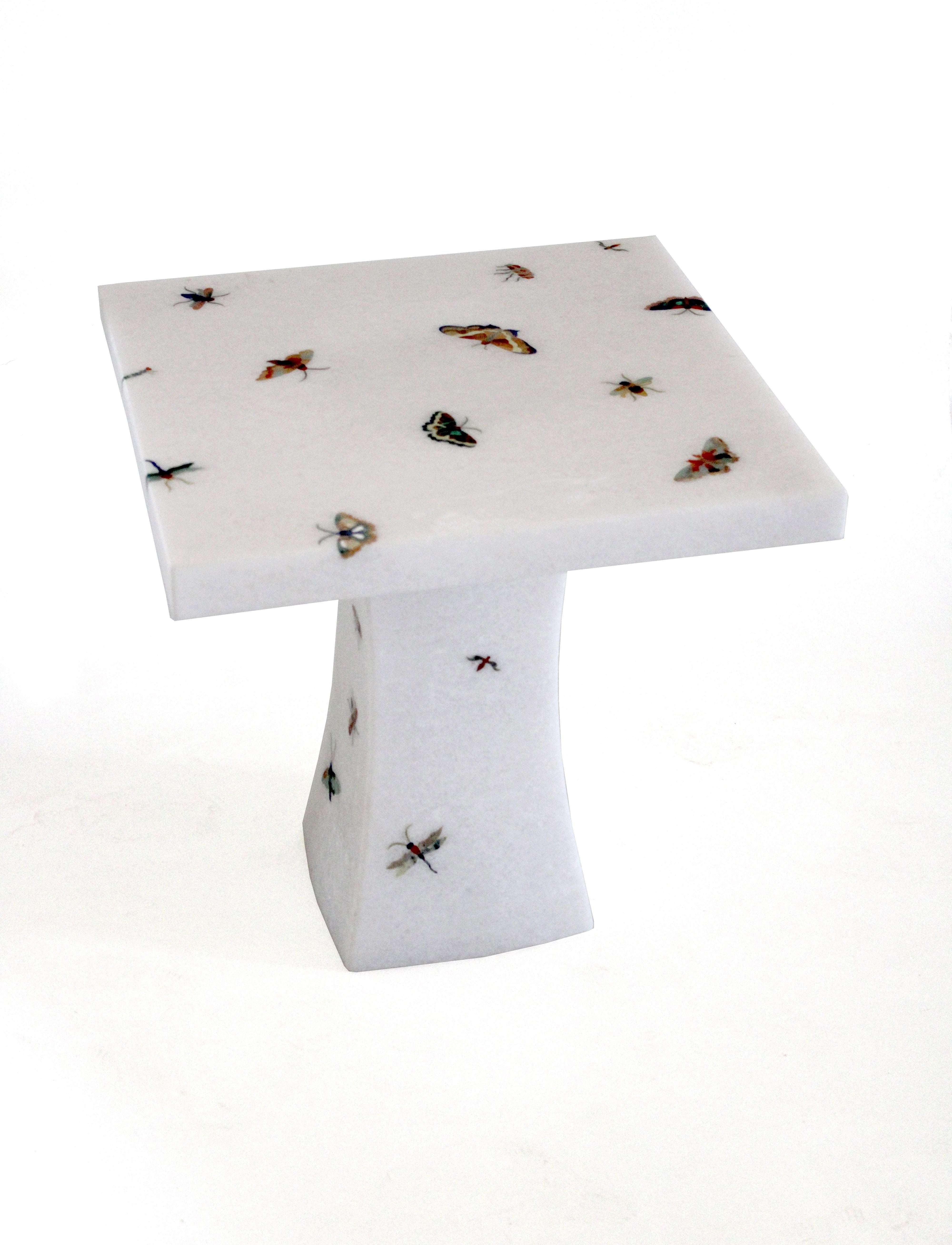 The butterfly table is a part of the Ornamenti collection. Delicately cut pieces of agate, tiger eyes, mother of pearl and other semi precious stones are made into butterfly patterns and carefully inlaid into the base stone by our master craftsmen.