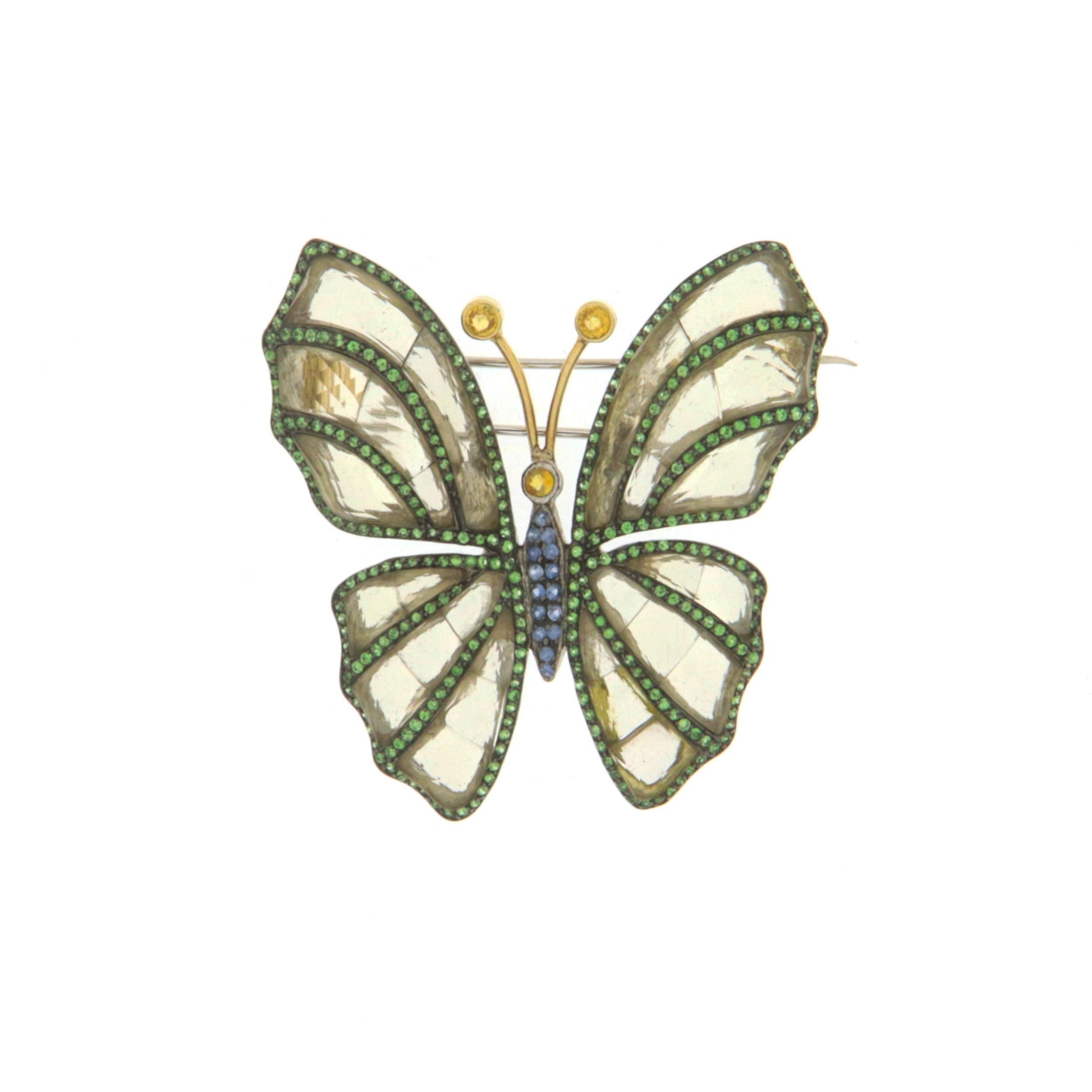 Butterfly 18 karat yellow gold and 925 thousandths silver brooch. Butterfly Handmade by craftsmen assembled with crystal rock,yellow and blue sapphires and tsavorite

Butterfly total Weight 20.80 grams