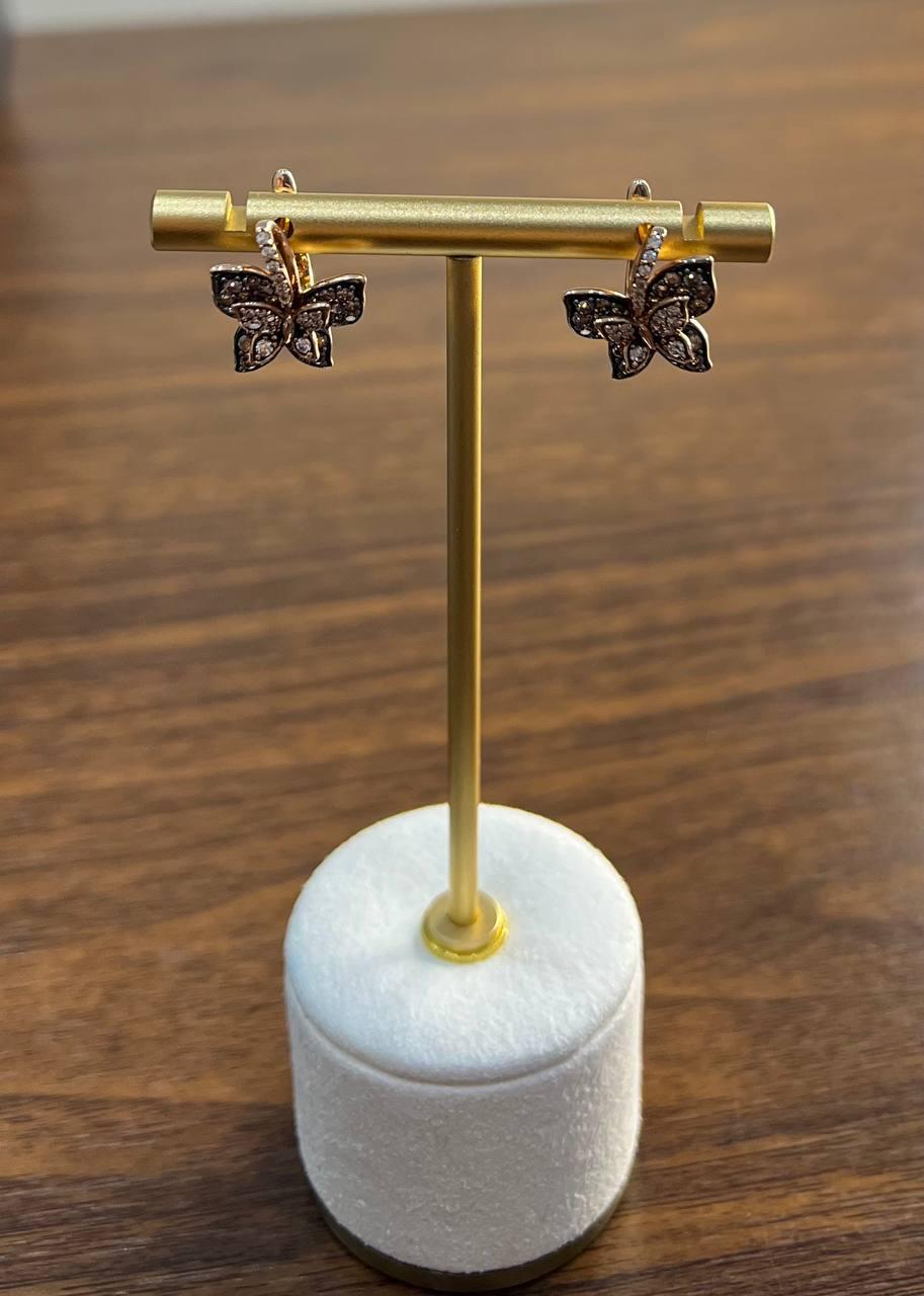 Butterfly Earrings, crafted with precision, feature a delicate butterfly design.

These earrings are adorned with sparkling diamonds in champagne, cognac and white colors, enhancing their intricate wings.

The gold-tone setting provides a luxurious