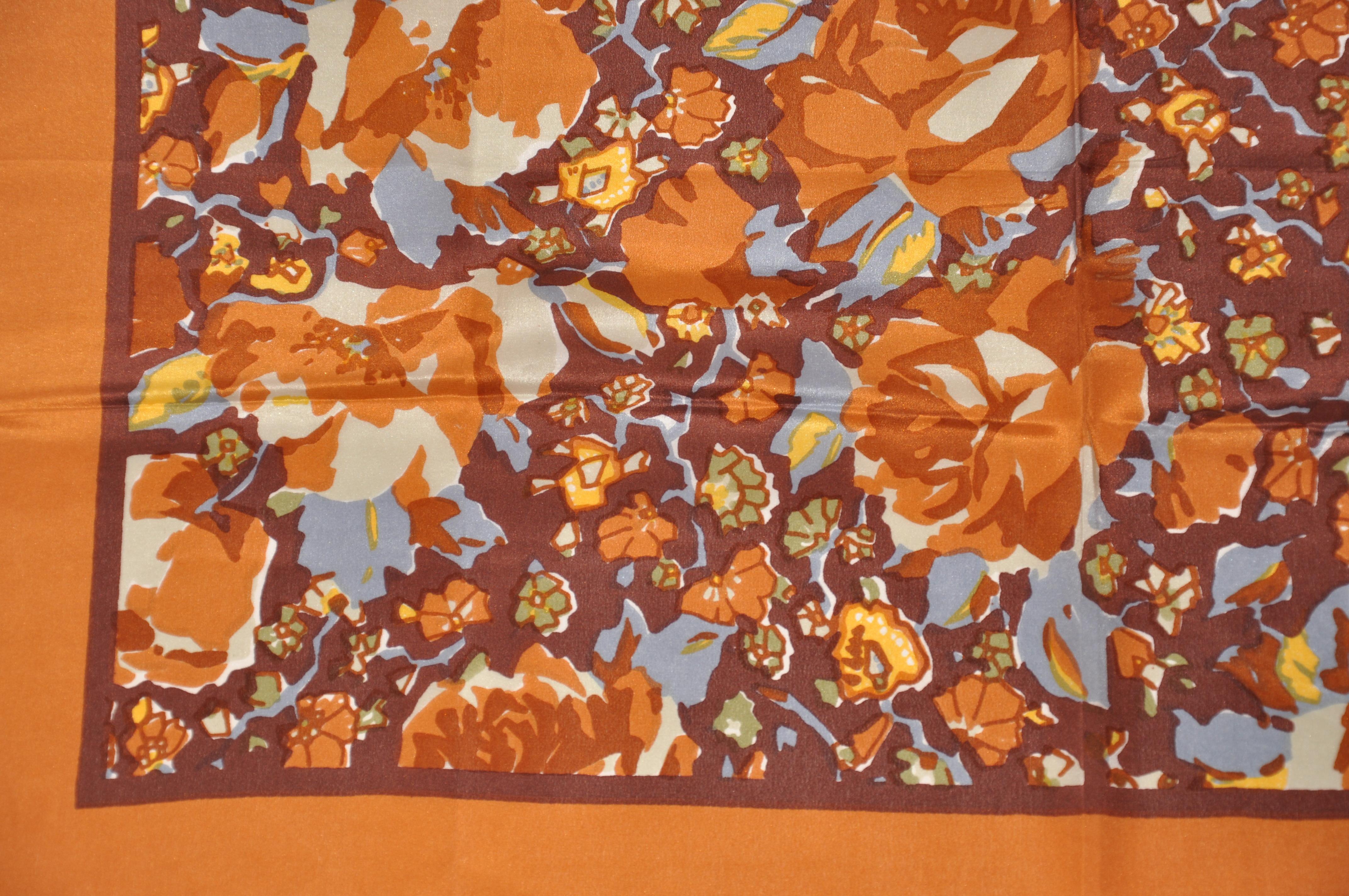 This wonderfully rich in tone Butternut floral silk scarf with hand-rolled edges, measures 27 inches by 27 inches. Made in Italy.