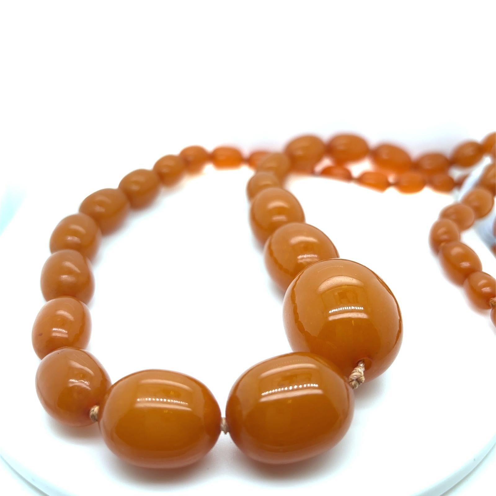 A butterscotch amber graduated long bead necklace.

The oval amber beads in this necklace graduate in size ranging from the largest centre bead of 3cm graduating down to 0.8cm at its reverse

The beads are double knotted for aesthetics and safety