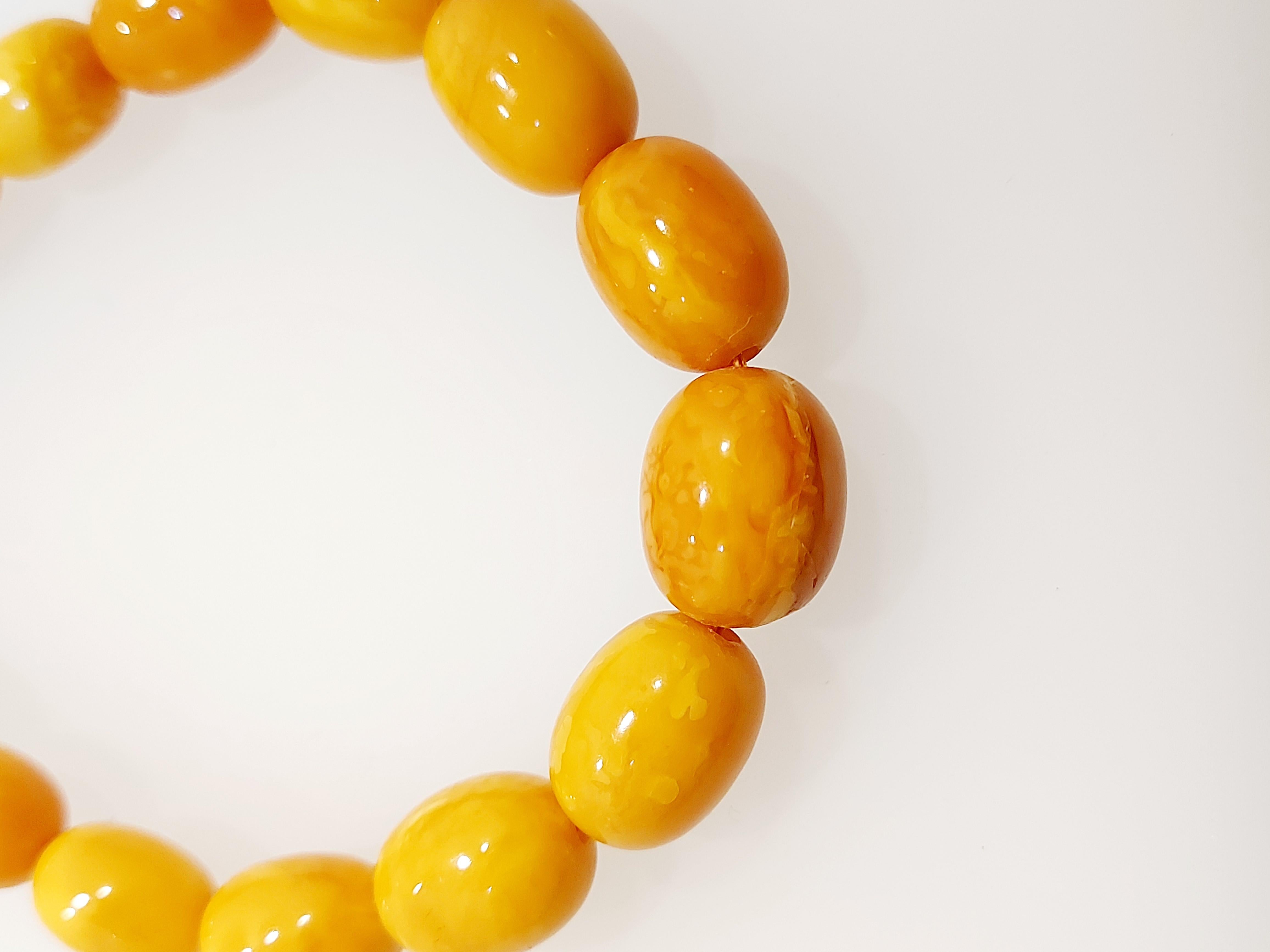 Graduated oval butterscotch baltic natural amber necklace from 7mm x 10mm to 13.8mm x 17mm knotted on a 9ct bolt ring fastener.