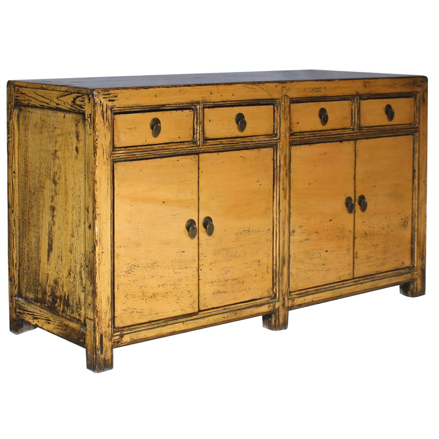 Four-door sideboard with butterscotch lacquer finish with clean lines and exposed wood edges. New interior shelves and hardware. Place in a contemporary living room below a flat screen TV, behind a sofa or use as a buffet in the dining room, circa