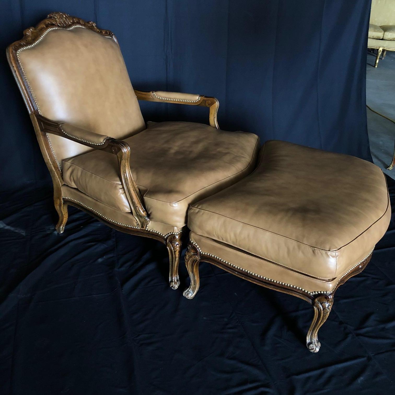 Distinguished Italian Louis XV style bergère chair and matching curved ottoman of generous proportions having a slightly slanted squared back, arched crest rail and rounded ears with straight, fluted, partially upholstered arms. Both have custom