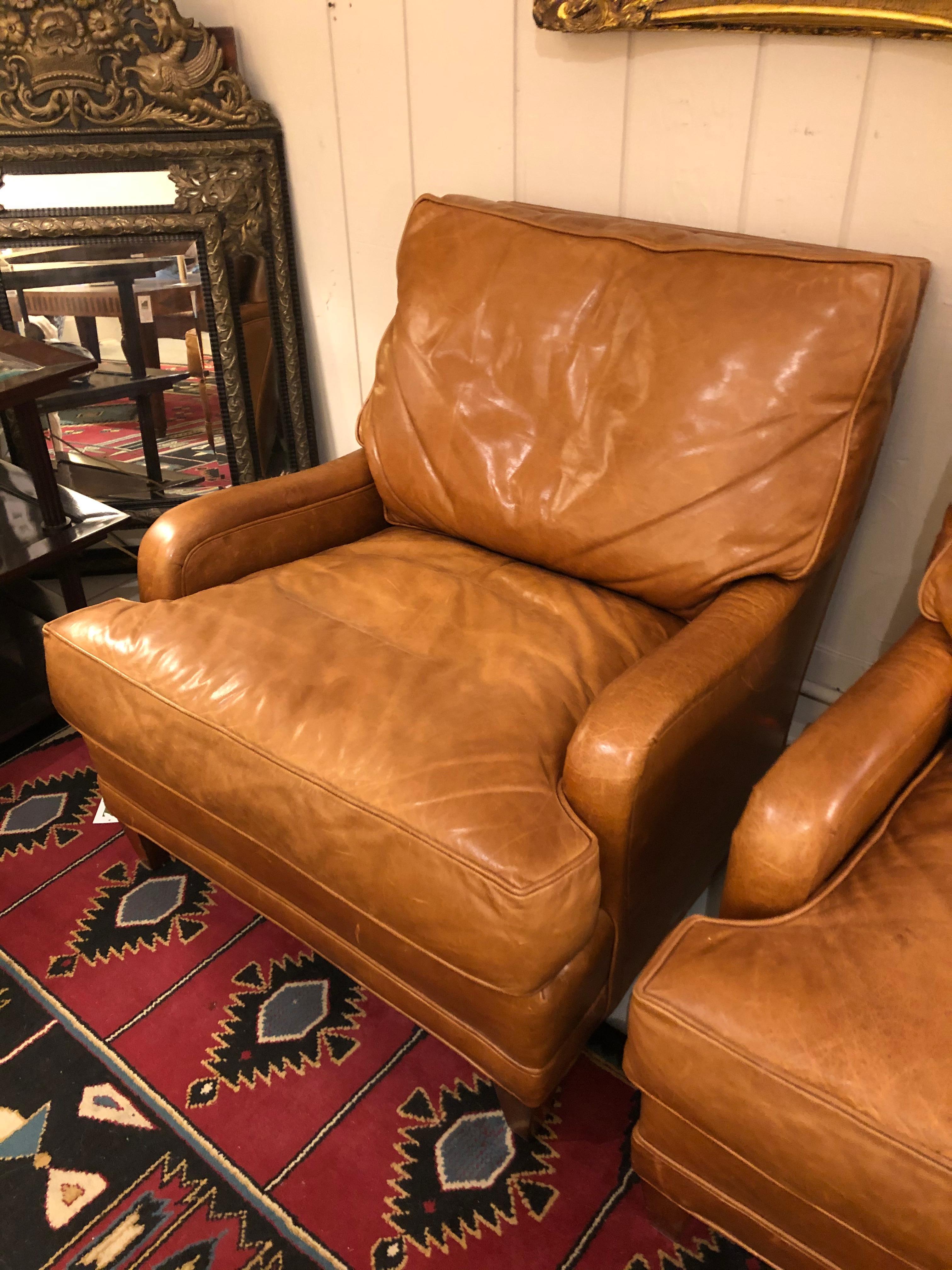 An enviably comfortable pair of luxurious butterscotch leather club chairs having Classic style and a top of the line maker, Nancy Corzine.