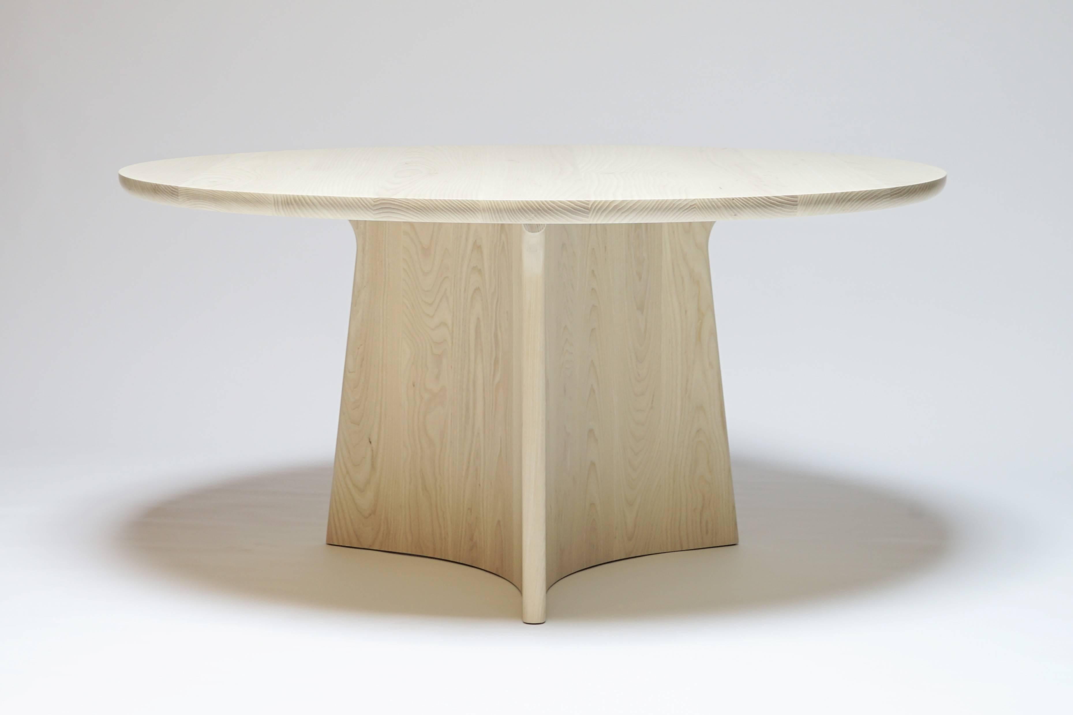 The Button dining table is a round pedestal dining table made from all solid hardwood. The hefty, three-point base means the table will not rock, while the wide overhang of the top means seats may be used anywhere around the table without