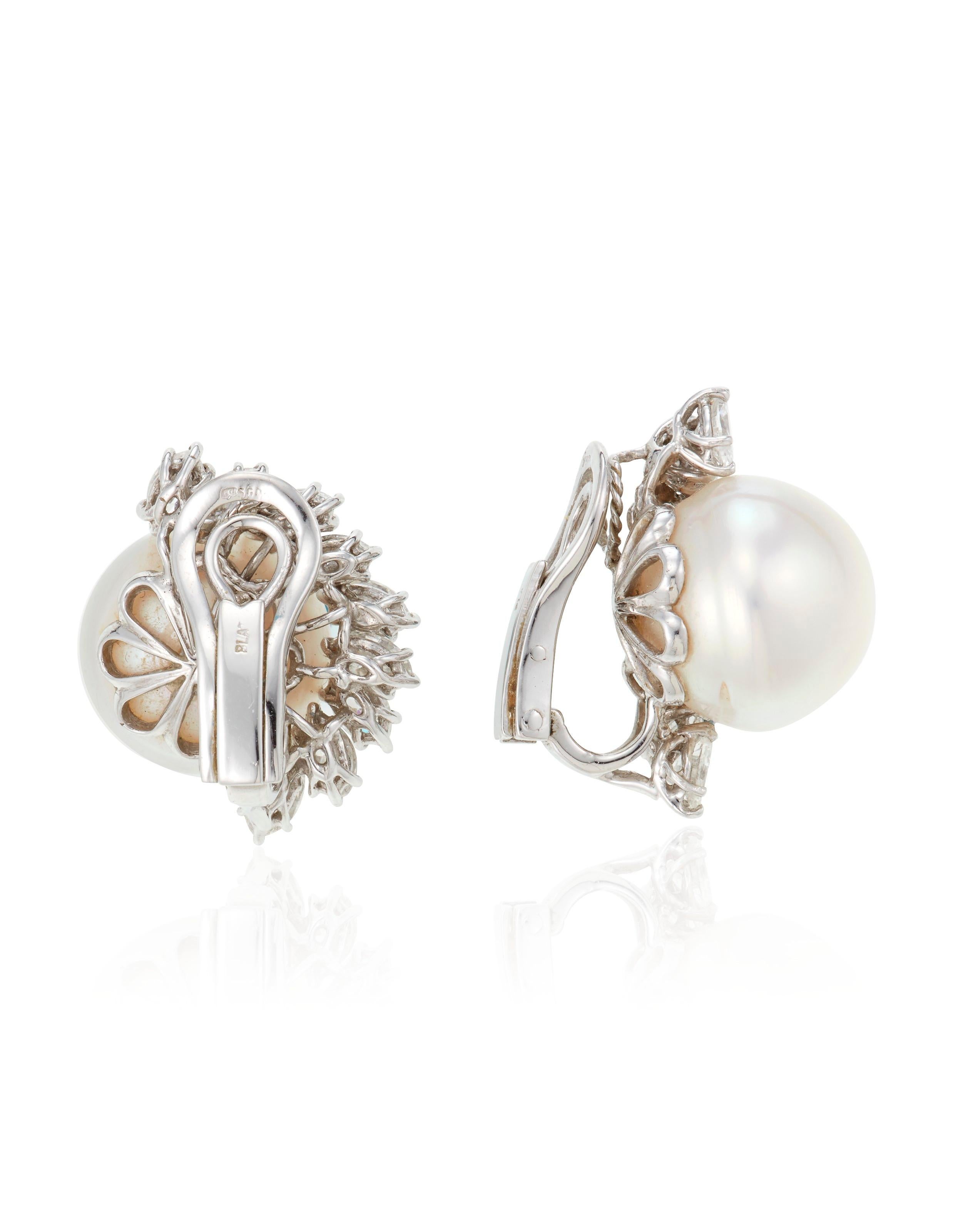 These fabulous earrings feature button-shaped cultured pearls, measuring approximately 14.60 and 14.40 mm, encircled with 18 marquise-cut diamonds, weighing approximately 2.20cts, set meticulously in platinum.

