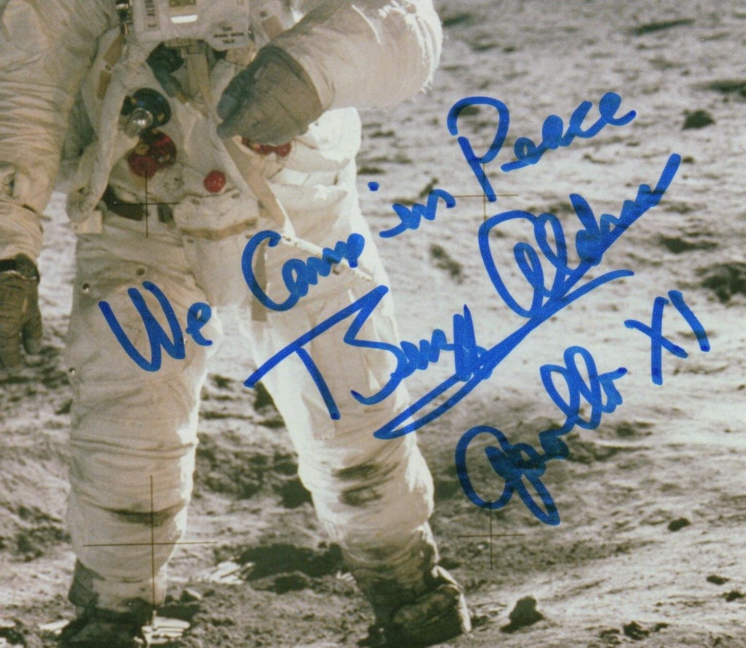 Presented is a signed color photograph of astronaut Buzz Aldrin during the Apollo XI Mission. In this NASA photograph, Aldrin, the lunar module pilot, walks on the surface of the Moon near the leg of the Lunar Module Eagle during the Apollo 11