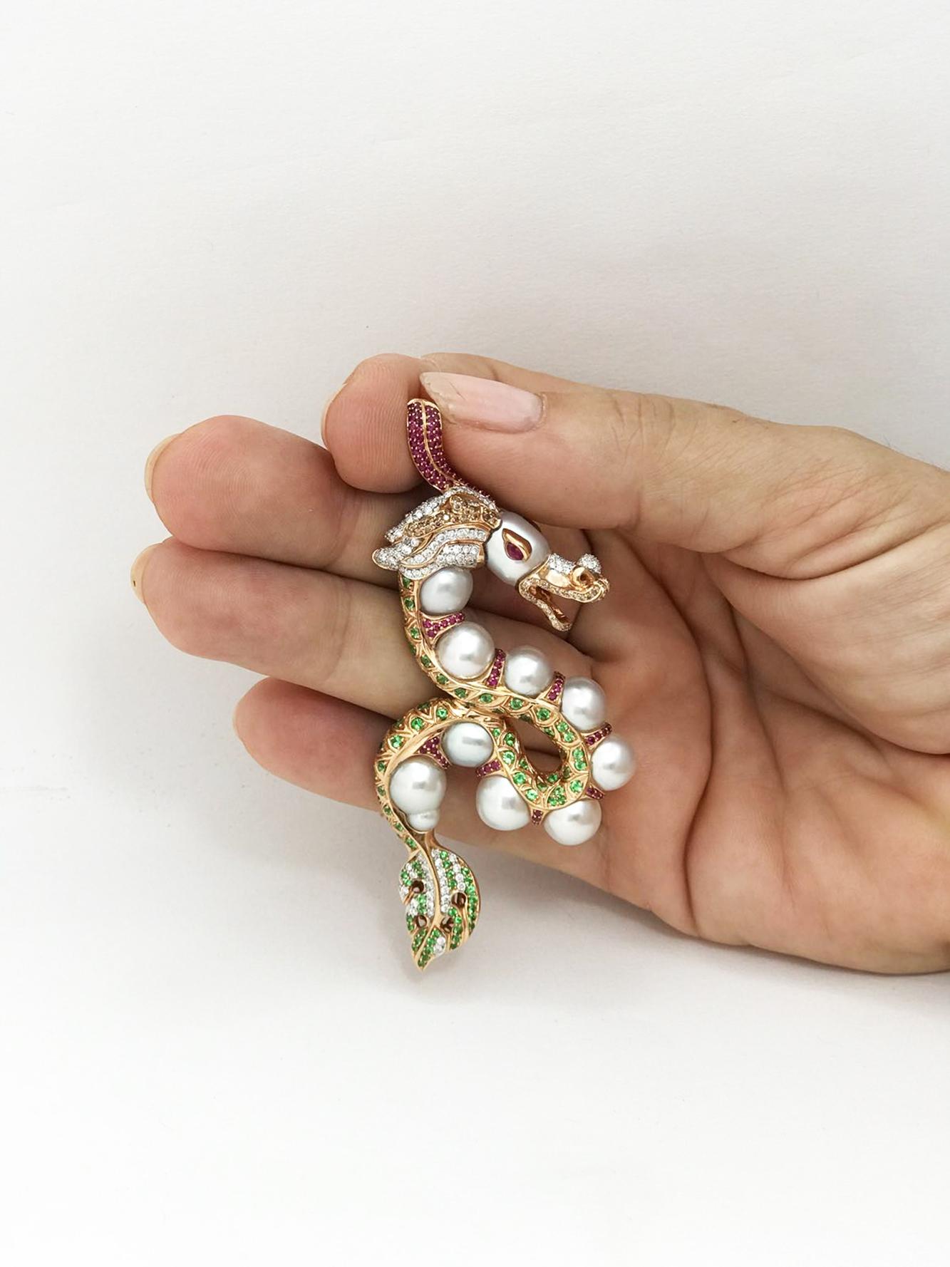 This unique one of a kind Dragon pendant has been crafted using lustrous  baby Australian south sea pearls, 10 pieces, measuring 8-9 mm.  The Dragon has been set with carefully selected red rubies, green tsavorites, brown and white diamonds.  Its a
