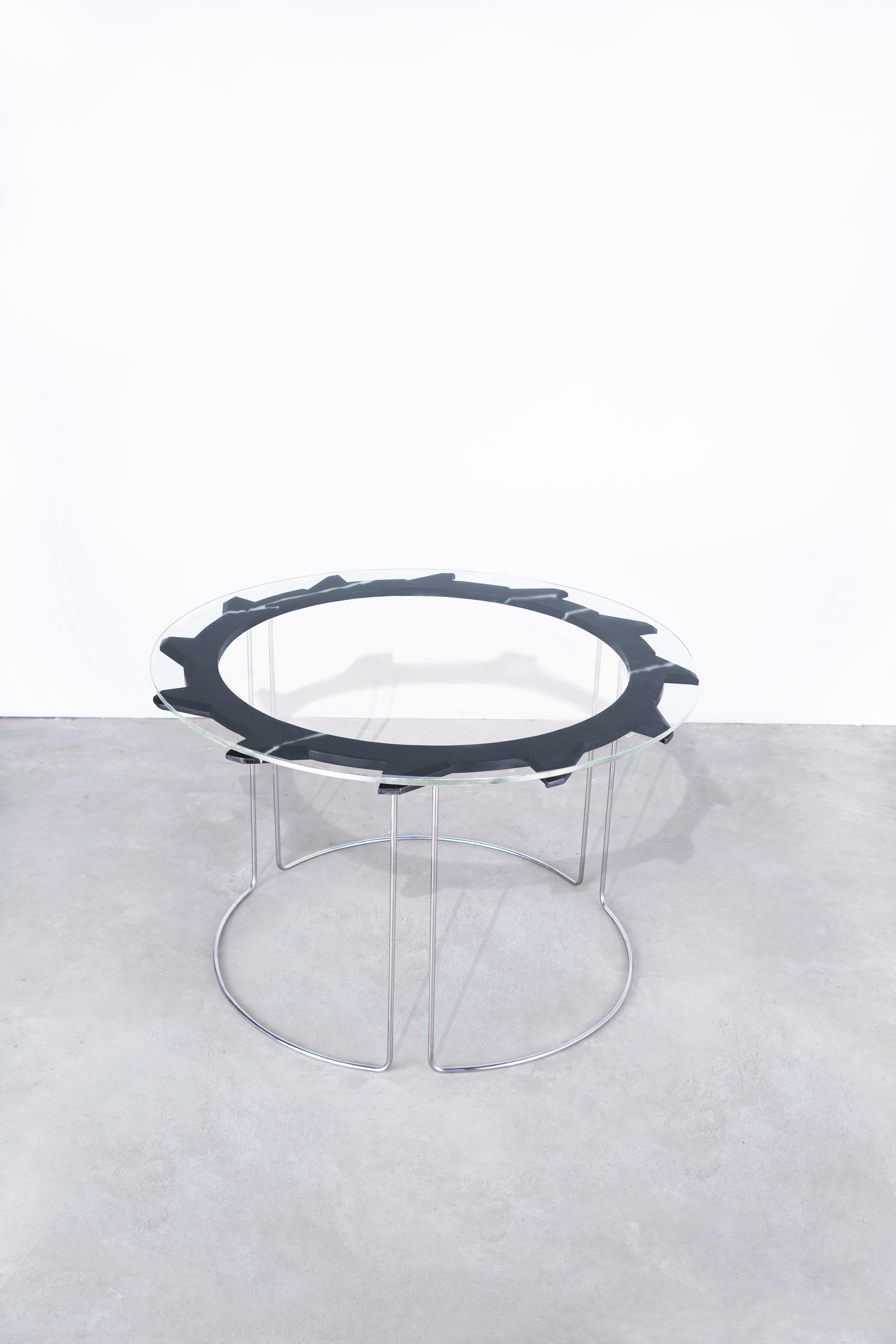 DESCRIPTION
Water jet cut, hand-beveled + hand-polished nero marquina marble table, with tempered glass top. 
Hand-formed + hand-polished stainless steel legs, welded into one continuous table base.
Starphire glass top. 
Position alone, or nest