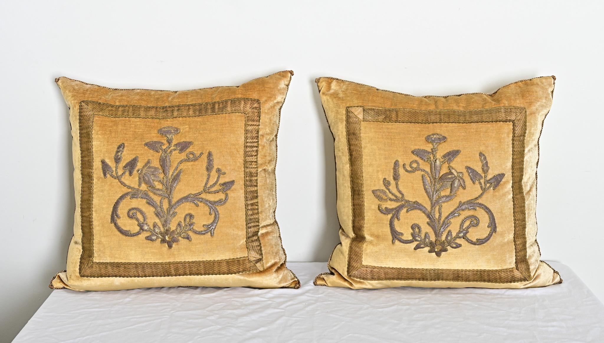 Recently made toss pillow pair from antique European raised gold embroidery of flowering, scrolling vines that have been framed with 18th century gold metallic galon (or galloon) trim against “Tawny” gold velvet. Hand trimmed with vintage gold