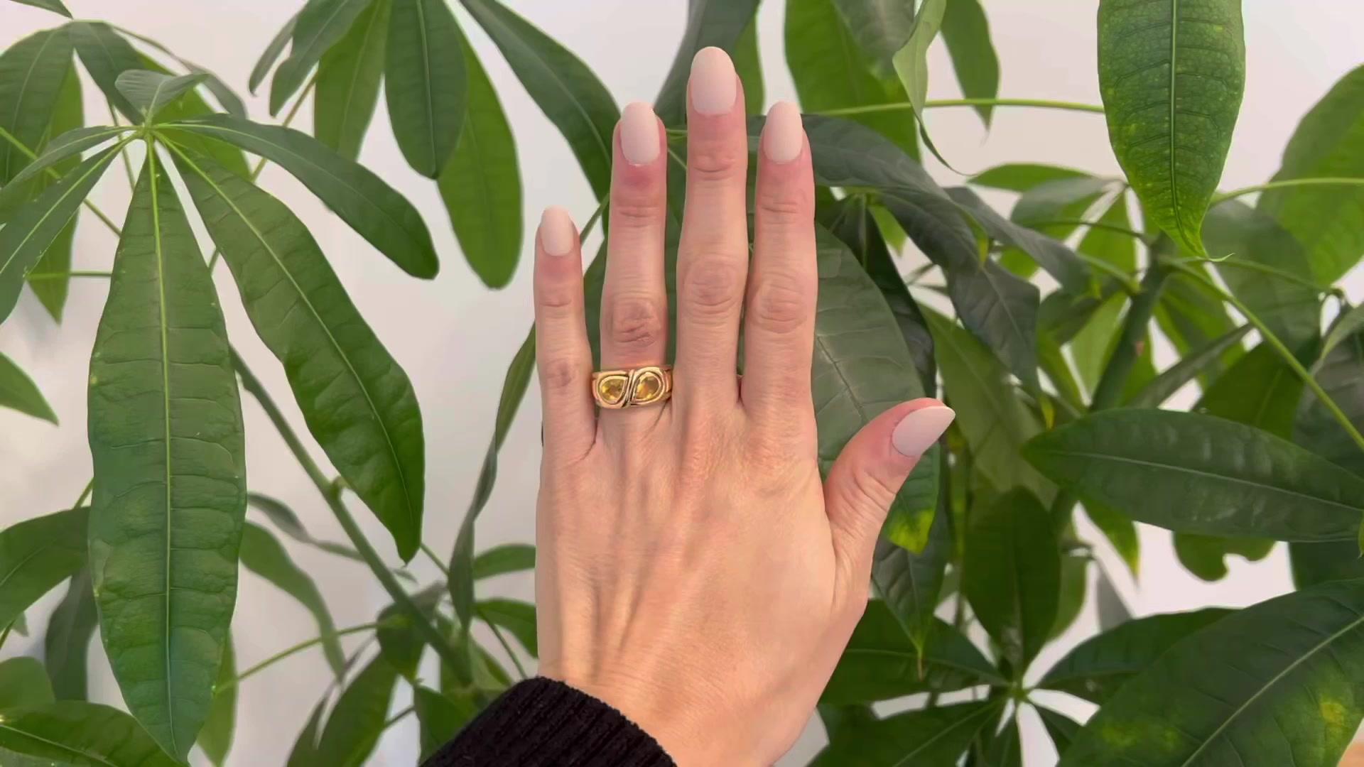 One Bvlgari  1.70 Carat Citrine 18 Karat Yellow Gold Band Ring. Featuring two pear shape cut yellow citrine with a total weight of approximately 1.70 carats. Crafted in 18 karat yellow gold with an 18 karat white gold interior band signed Bvlgari