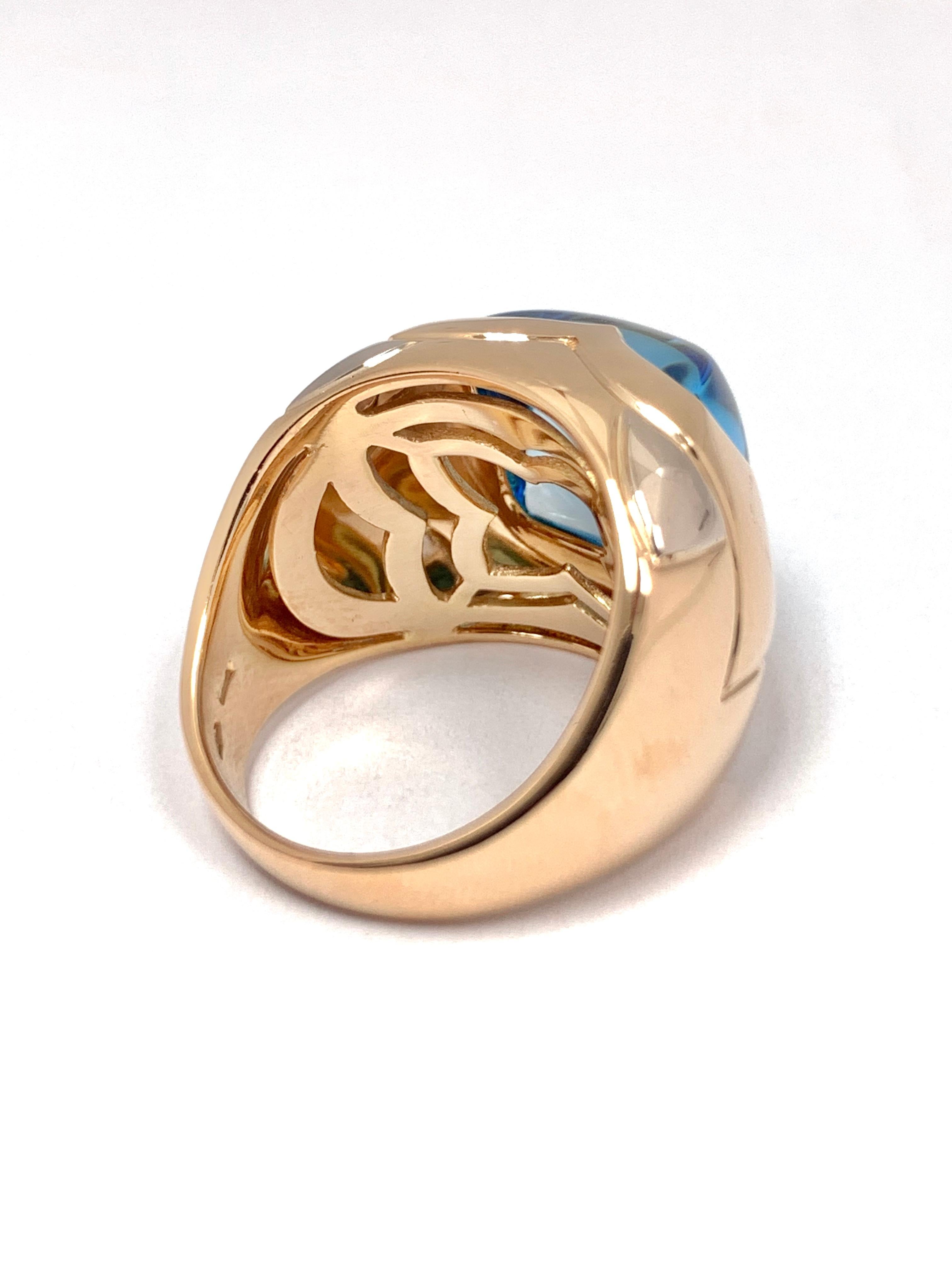 Bulgari ring finely crafted in 18K gold, Set with a sugarloaf cabochon blue topaz in two tone gold.
(Yellow gold with white gold corner details) 
From the 