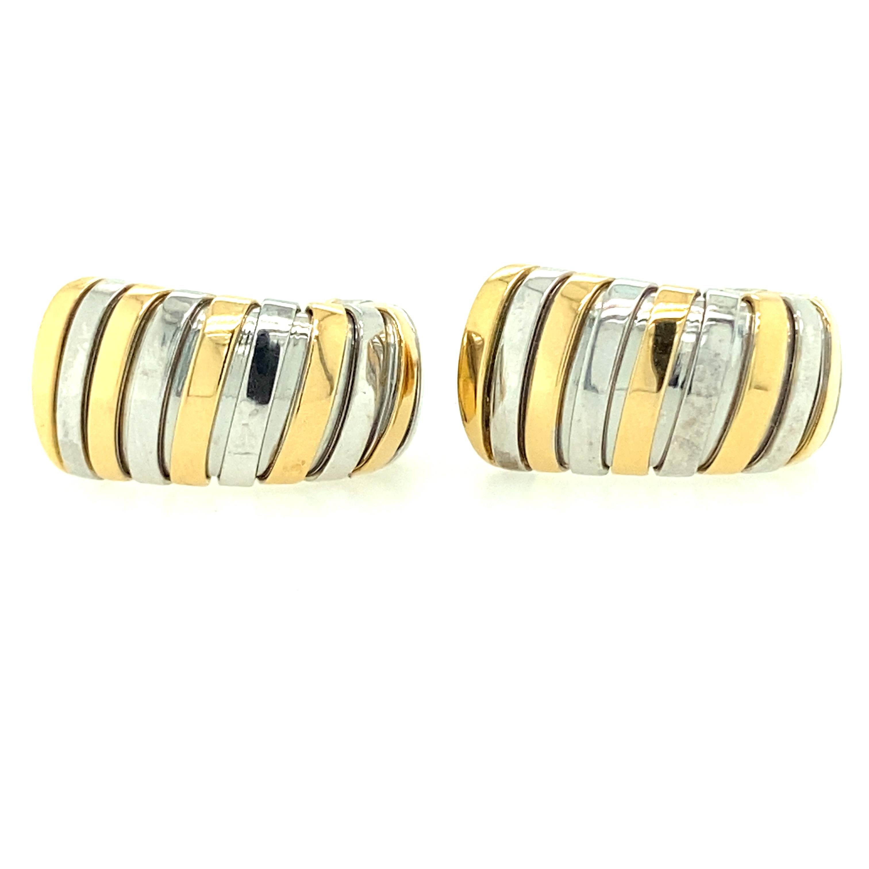 One pair of 18 karat yellow and stainless steel high polished Bvlgari earrings from the Tubogas collection (stamped 2337 AL,  750,  MADE IN ITALY). The earrings measure 23.07mm long and taper from 12.08-10.73MM wide. The earrings feature posts with