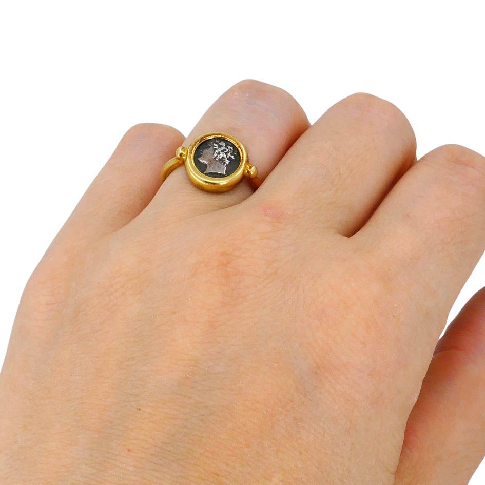 This authentic circa 1980s Bvlgari 18k gold Monete ring features an ancient Greek coin from Gallia Massalia (385–220 B.C.) set in a bold yellow gold bezel. The coin face, measuring approximately 1/2 inch in diameter, displays a classical profile