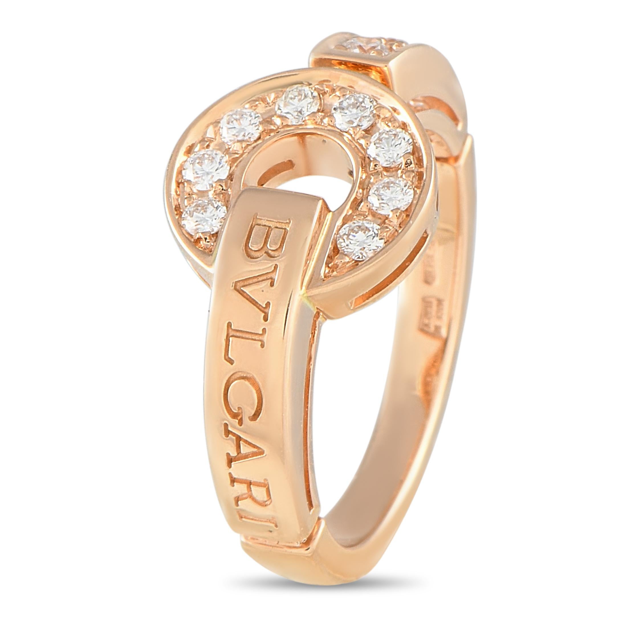 This Bvlgari Bvlgari 18K rose gold ring showcases the fusion of boldness and refinement. It has Bvlgari's trademark double logo inscribed on the band. Enhancing the ring's beauty are pav-set diamonds on a circular design. This signed ring has a top