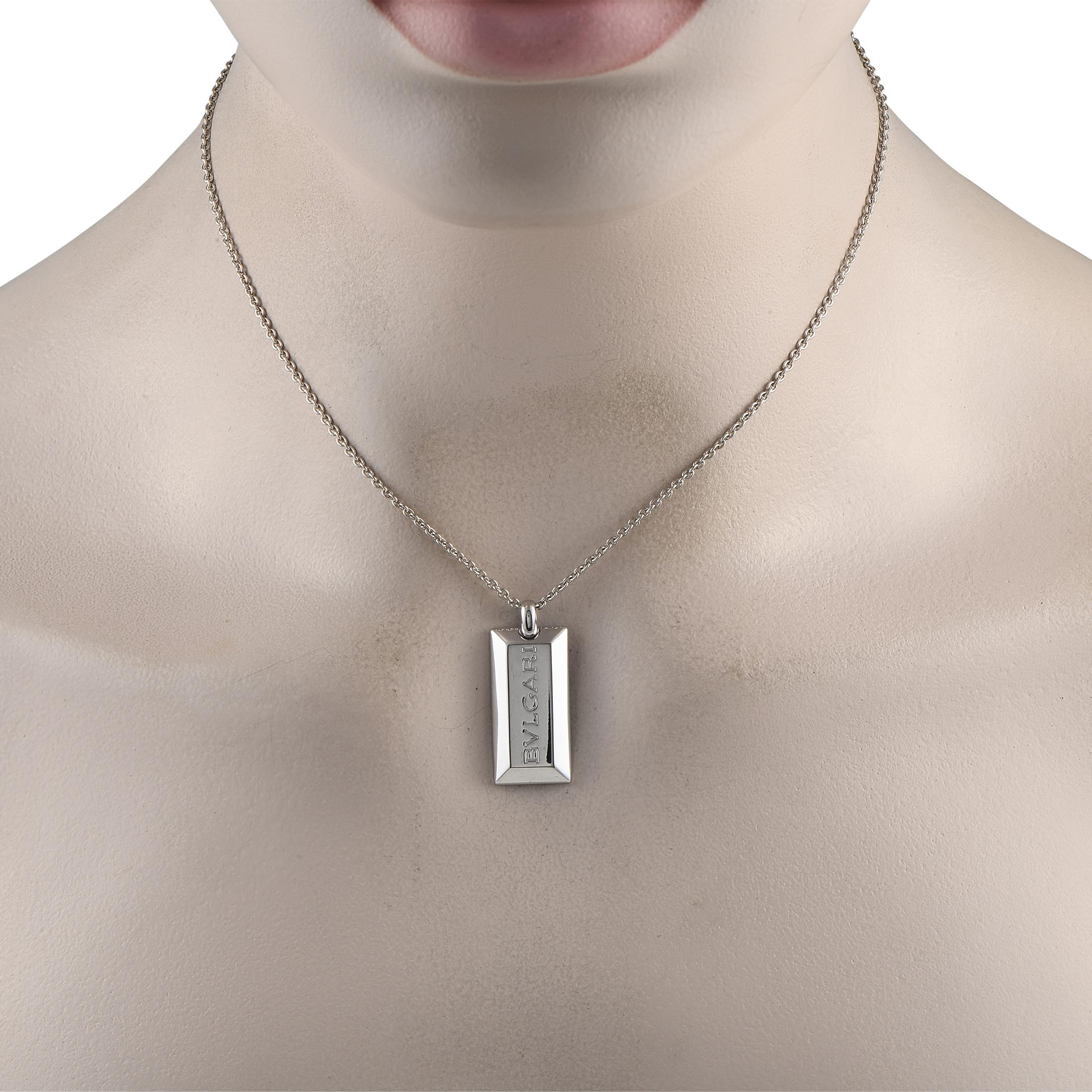 This is a versatile and minimalist Bvlgari necklace showcasing fine craftsmanship with its simplistic and clean design. It features a 15-inch-long white gold chain holding a white gold block pendant in a smooth, polished finish. The necklace is