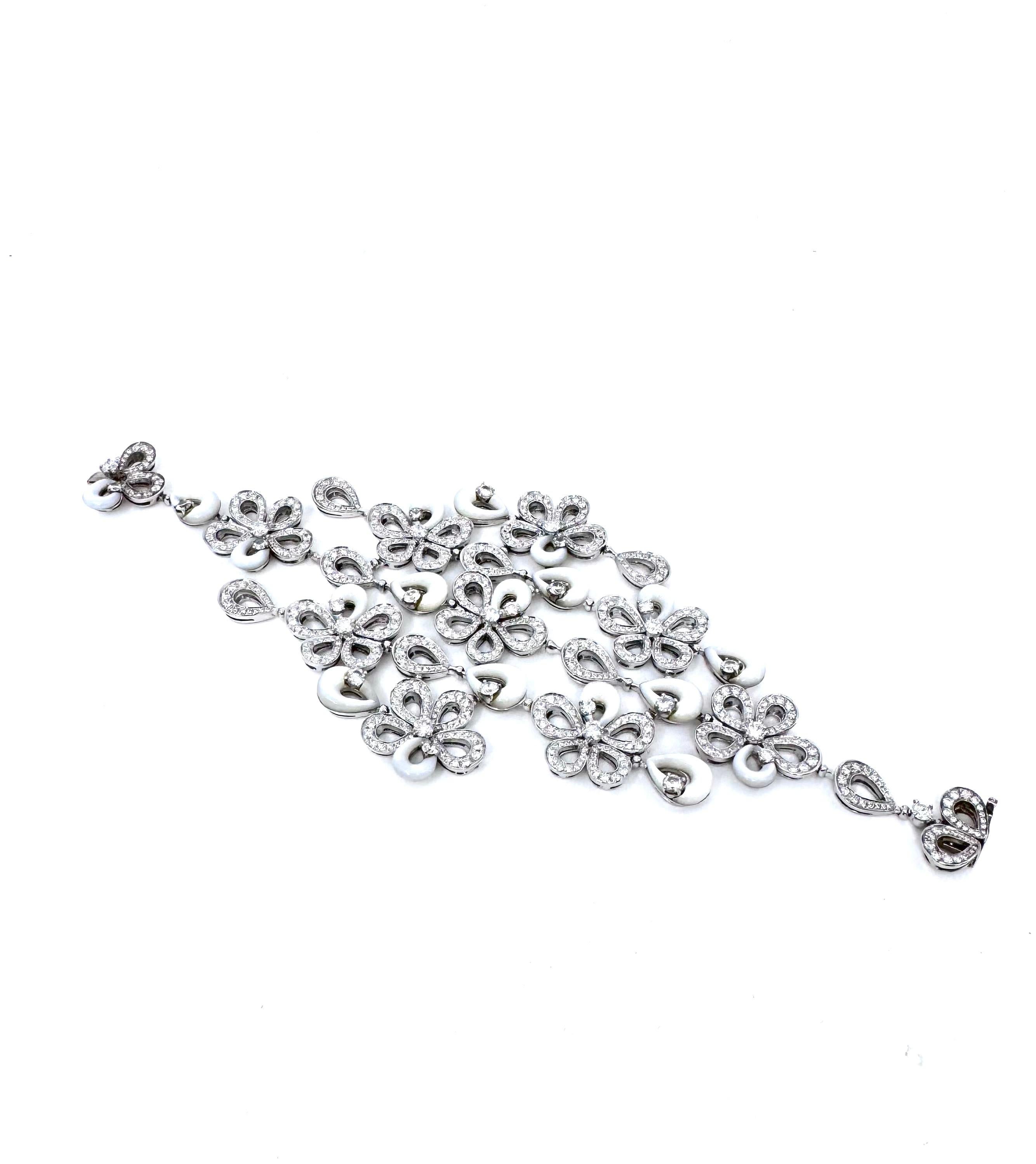 Part of Bvlgari's renowned High Jewelry collection, this bracelet showcases the brand's signature blend of luxury and artistry. Crafted in 18K white gold, it features luminous mother of pearl elements accented by 8.87 carats of pavé diamonds (F-G