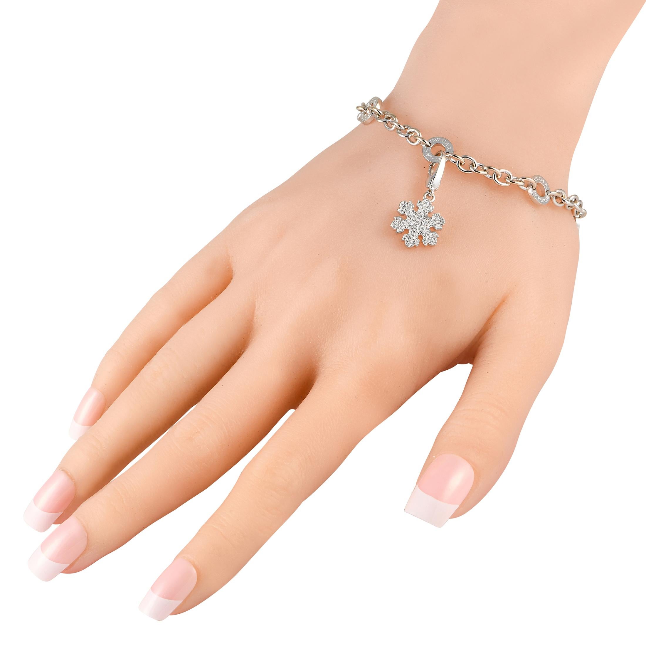 An exquisite snowflake charm covered in sparkling Diamonds serves as a stunning focal point on this Bvlgari bracelet. Simple and elegant, its crafted from 18K White Gold and measures 8.0 long.This jewelry piece is offered in estate condition and