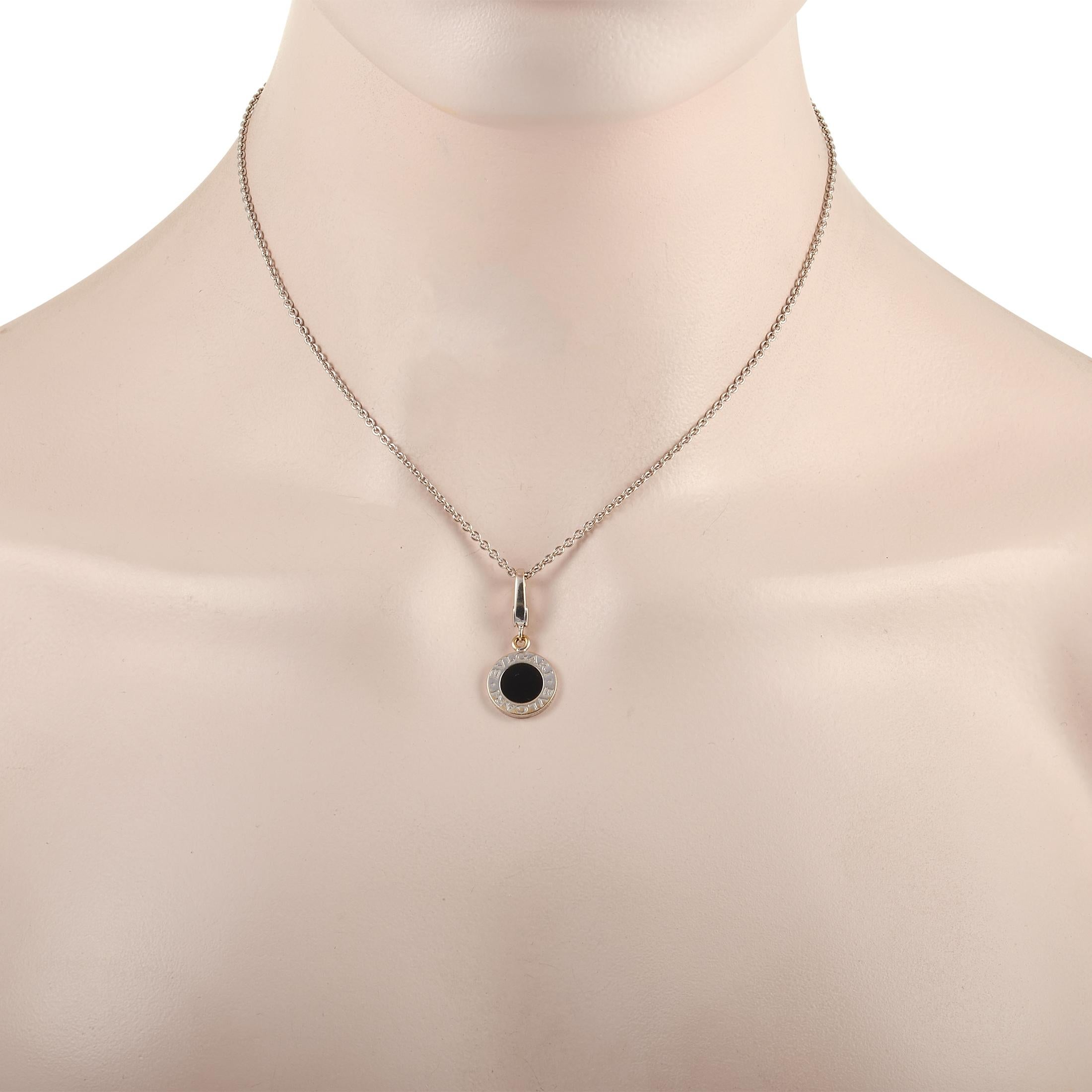 This classic Bvlgari necklace isn’t shy about name-dropping. The necklace is made with an 18K white gold chain measuring 18 inches in length and features a round 18K white gold set with a sleek onyx gemstone. The outer white gold disc bears the