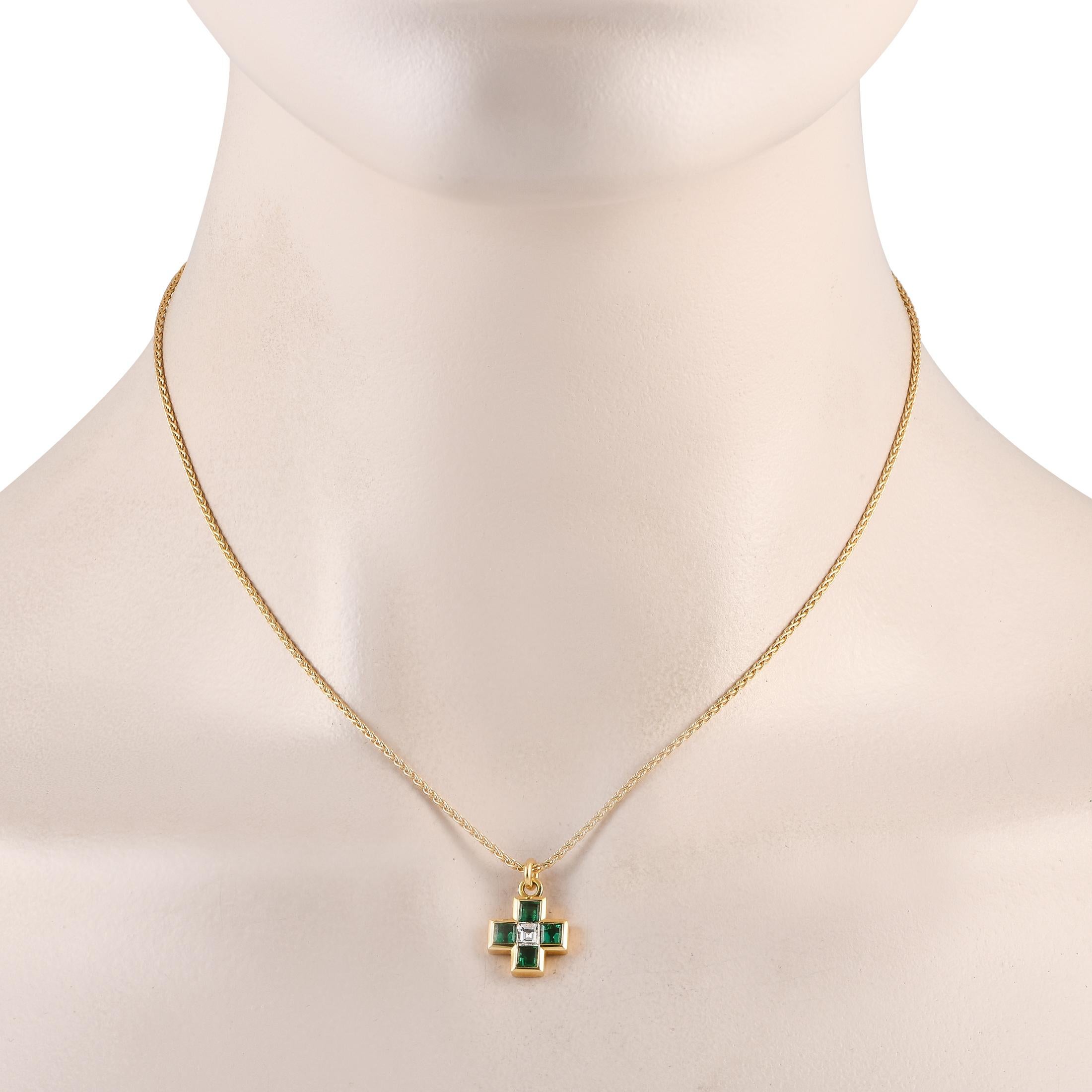 Crafted from opulent 18K yellow gold, this Bvlgari necklace is a timeless piece that will never go out of style. Square-cut emeralds totaling 0.70 carats and a square-cut 0.18 carat diamond add plenty of sparkle to the cross-shaped pendant, which