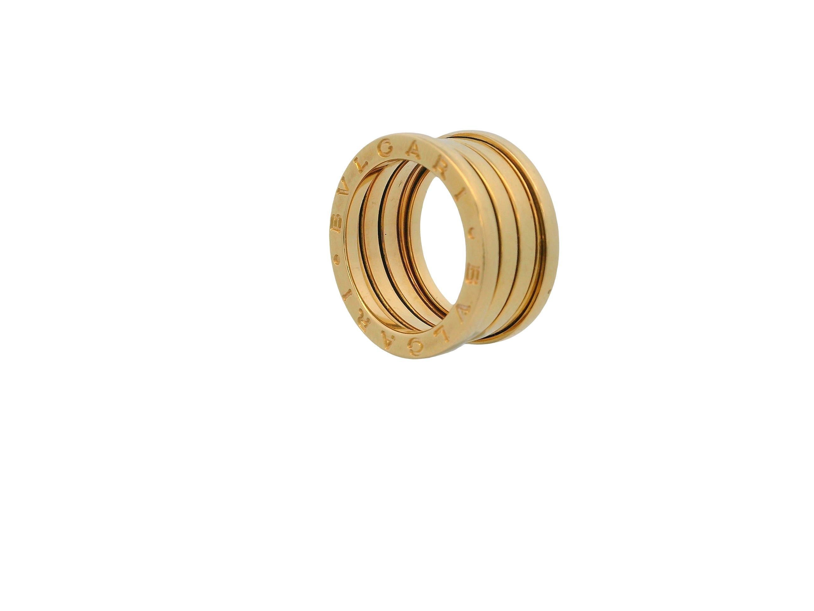 The contemporary Bvlgari ring embodies a blend of modern elegance and simplicity. It features a sleek design with five bands stacked together, all made from 18k yellow gold. The ring's surface is smooth and polished, which enhances its luxurious