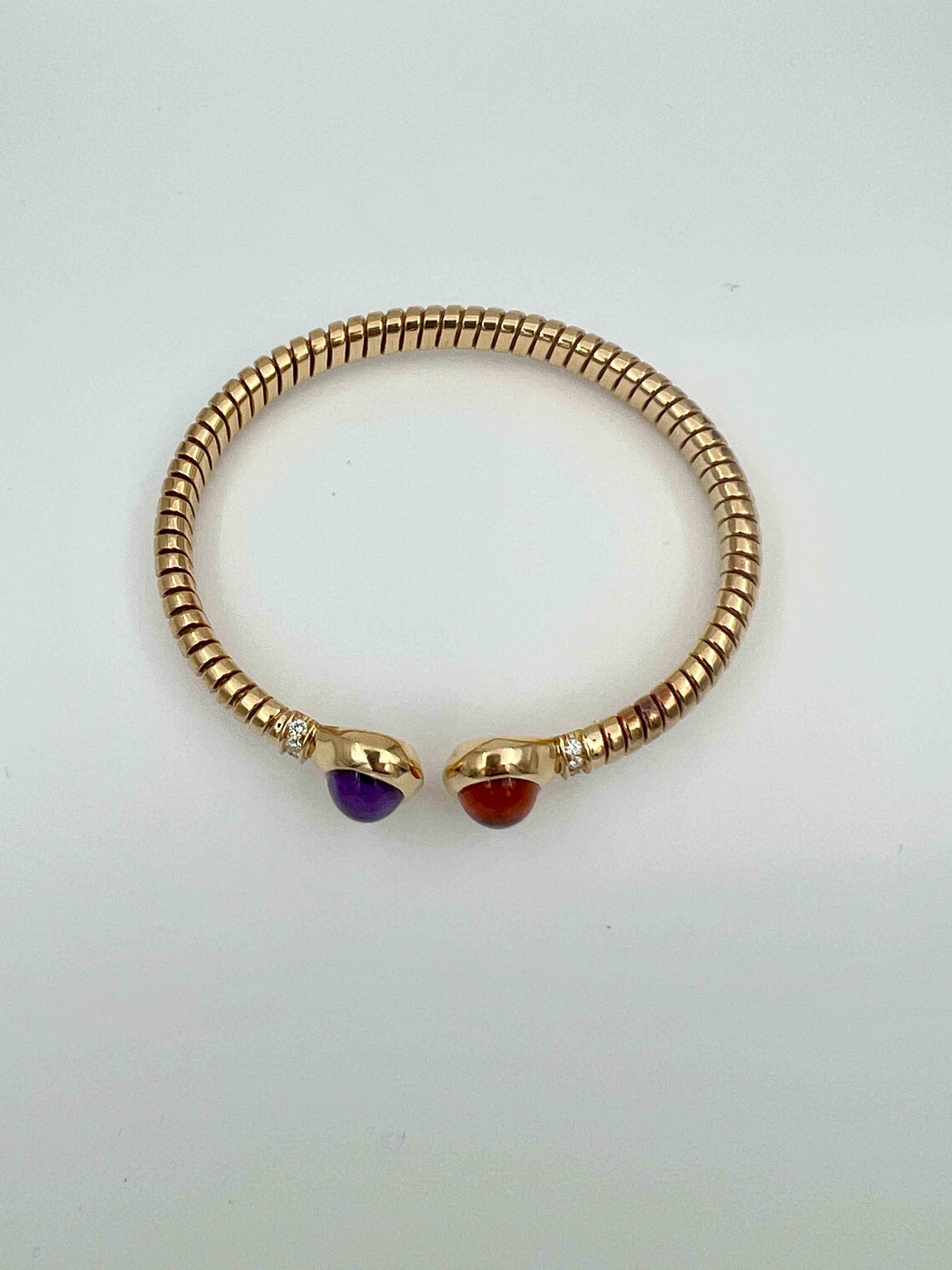 Introducing a stunning vintage Bvlgari bangle bracelet set, adorned with exquisite amethyst and citrine stones. This timeless piece exudes elegance and sophistication, making it a perfect addition to any jewelry collection. The rich, deep hues of