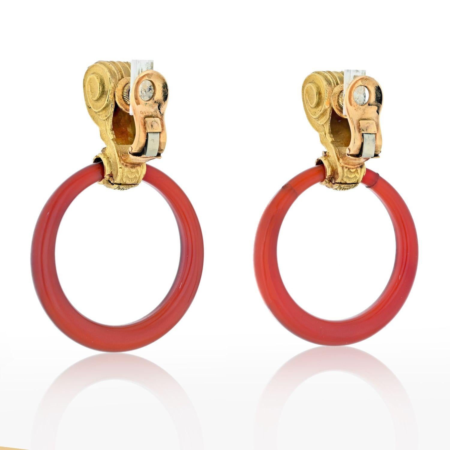 Of door knocker design, in articulated 18K yellow gold, with clip backs these are vintage Bvlgari door knockers with hoops made of Carnelian. 
Because these earrings come to us from 1970's there are some signs of wear on one of the carnelian hoops.