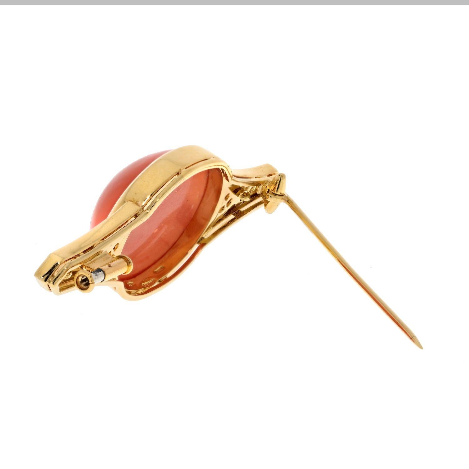 Experience the timeless elegance of an estate Bvlgari 18K Yellow Gold Coral, Black Enamel, and Diamond Brooch. This exceptional piece showcases a vibrant orange cabochon-cut coral, measuring 24mm by 20mm, radiating with the warmth of the