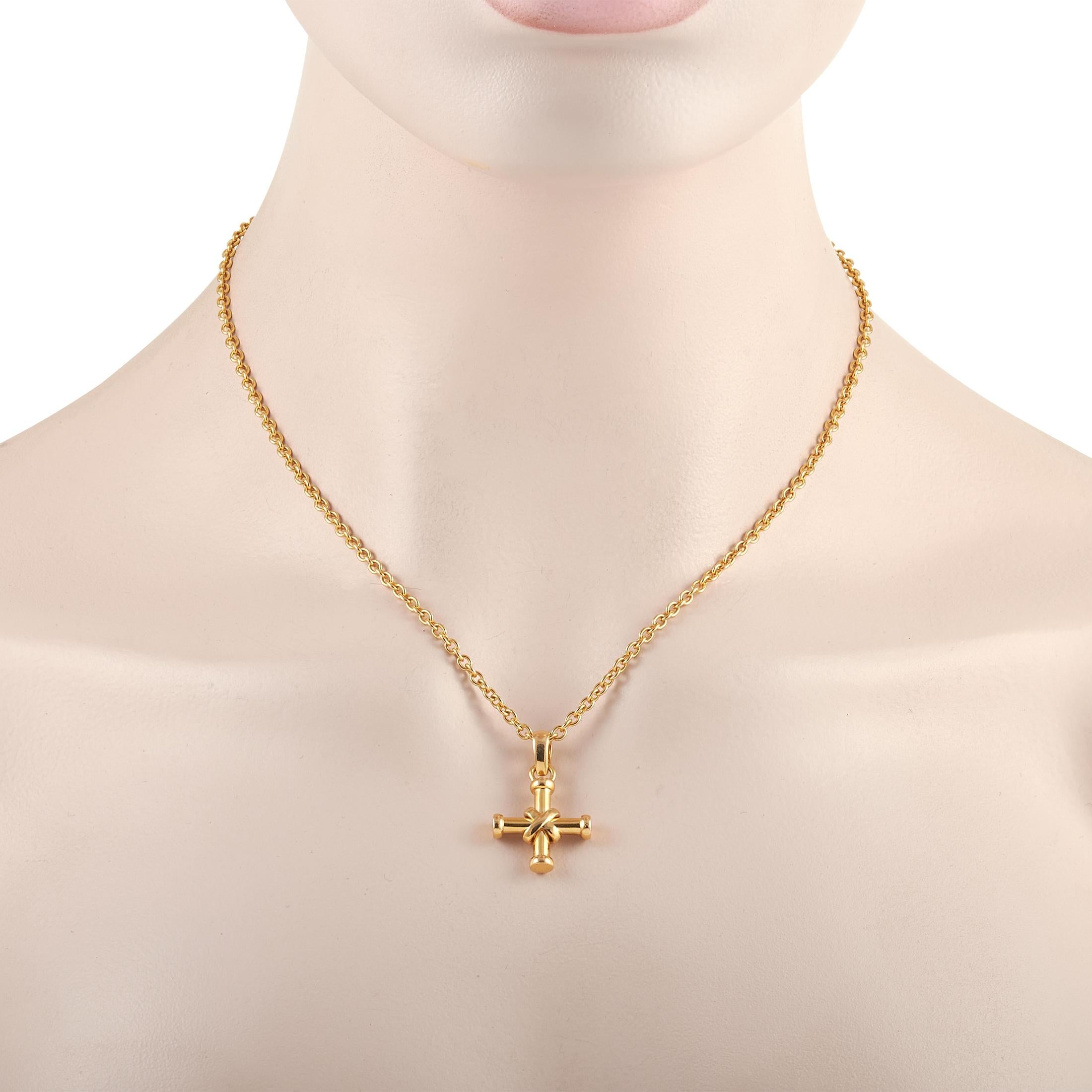 This Bvlgari 18K Yellow Gold Cross Necklace is made with an 18K yellow gold chain highlighting a matching 18K yellow gold cross. The chain measures 17 inches in length and features a lobster closure. The cross pendant measures 1.13 inches in length